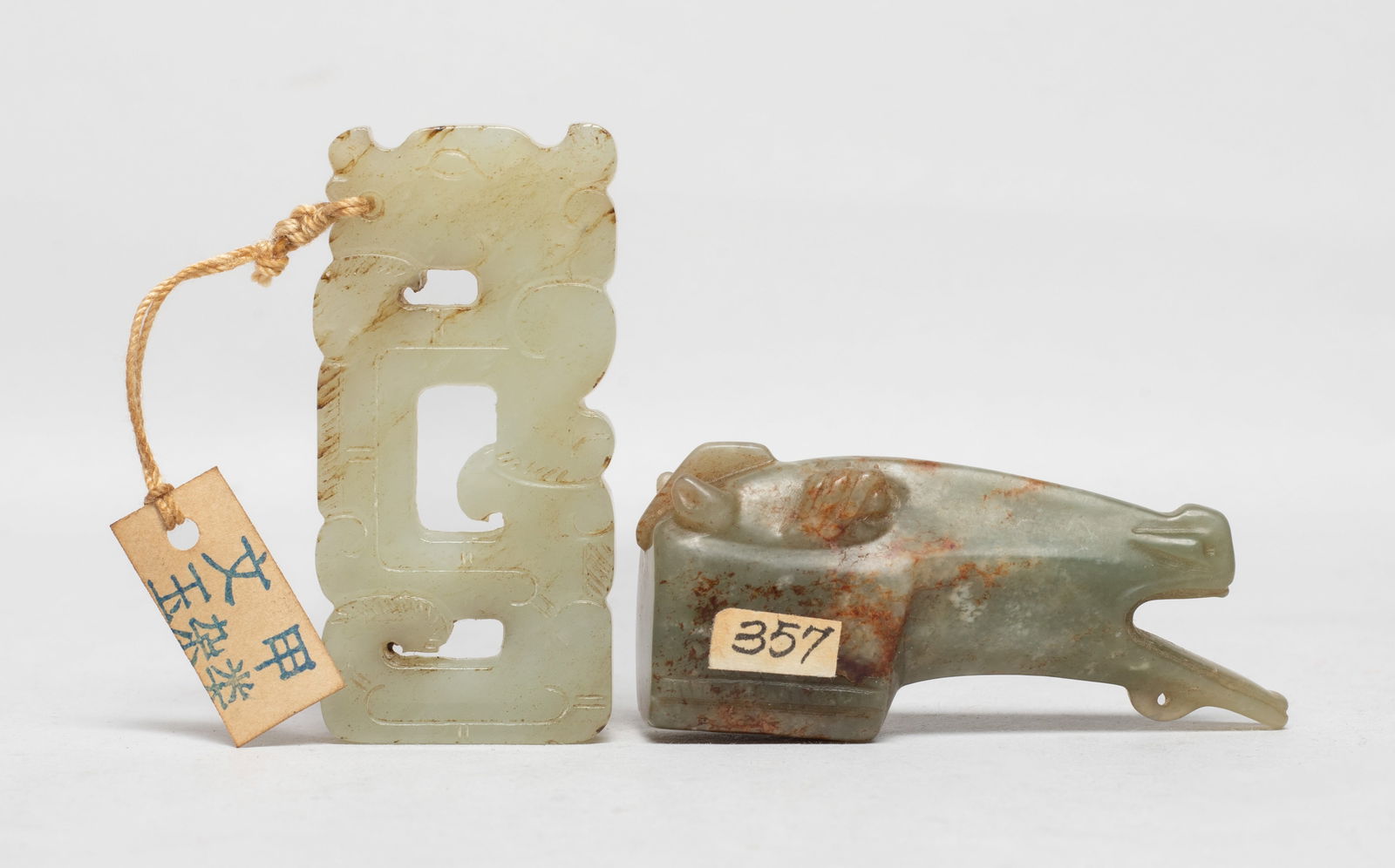 Estate Two Chinese Jade Carved Pendants: Including a russet jade pendant carved as horse head, and a pale celadon jade pendant carved of S-shaped dragon profile. Approx. 2.54*1.1*0.67 inch (larger). The Estate of the Consignment Store Closed