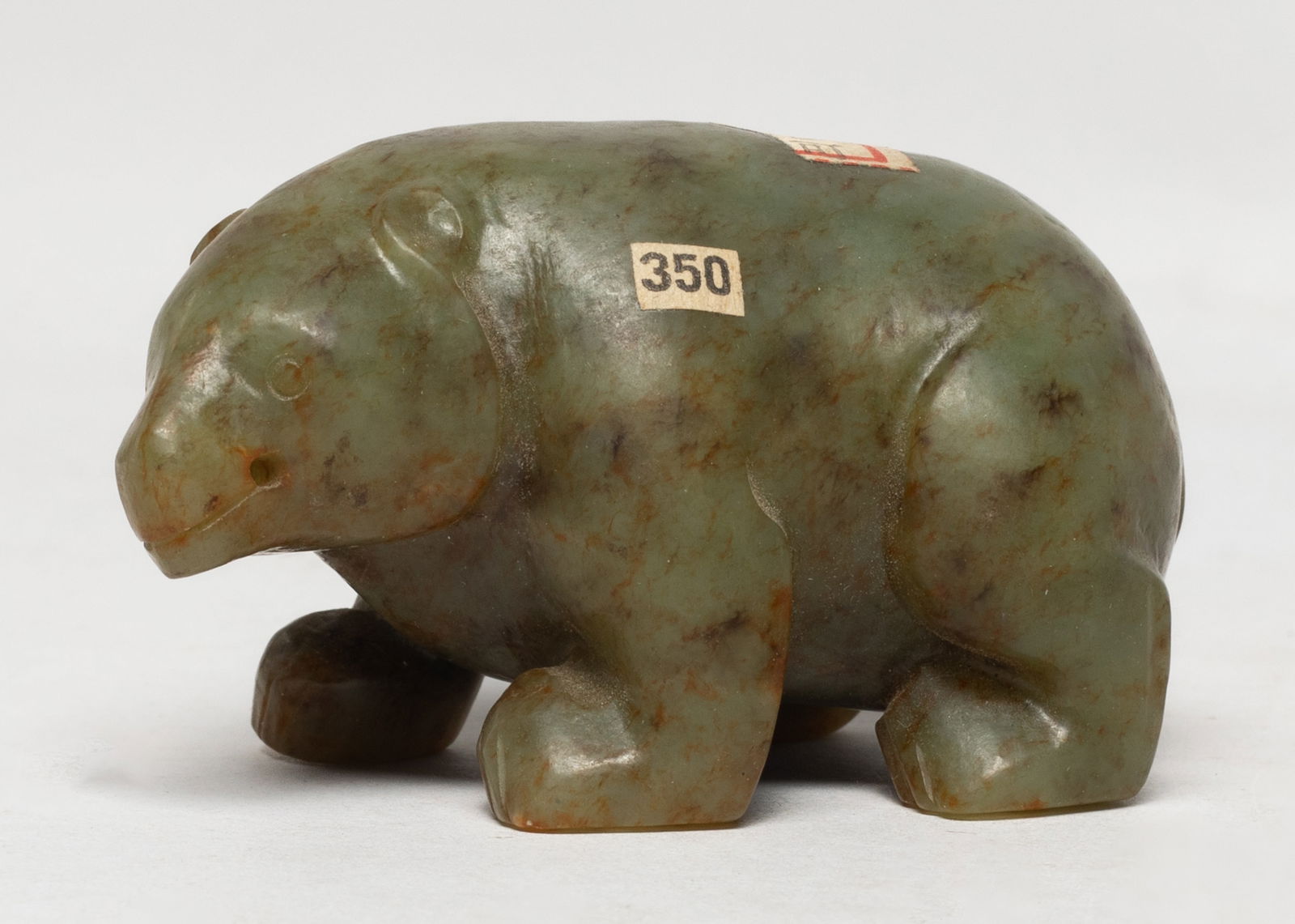 Chinese Russet Jade Sculpture: Chinese russet jade sculpture carved of bear form, the bear head turned slightly to the left. Approx. 2.77*1.6*1.5 inch. The Estate of E Los Angeles, CA. 2022.