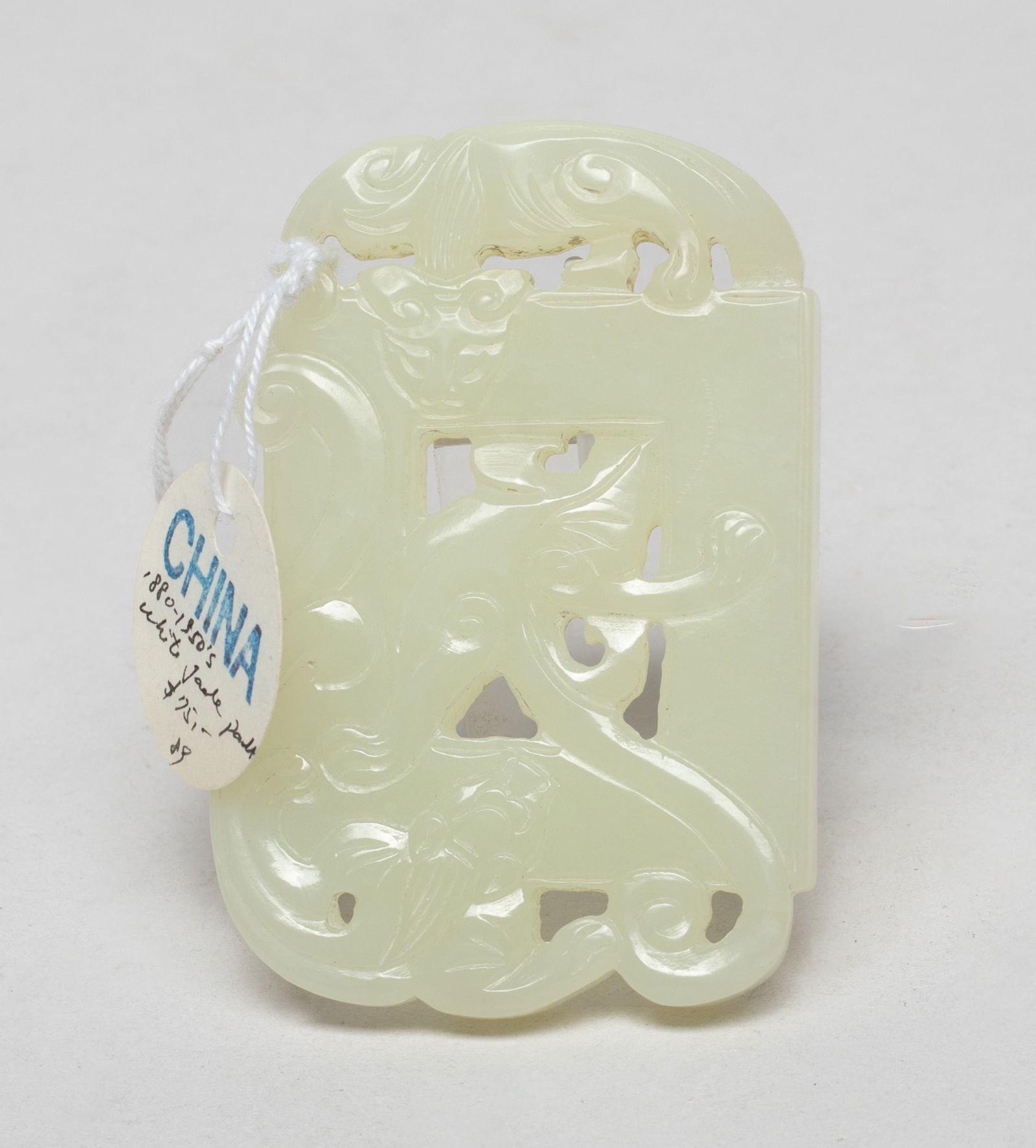 Chinese Export Jade Pendant: Carved as an square plaque, surrounded by two pierced sinuous chilong, the elongated body through the plaque centre. Approx. 2.8*1.9 inch. The Estate of the F. C. Chung. SF. 2012.