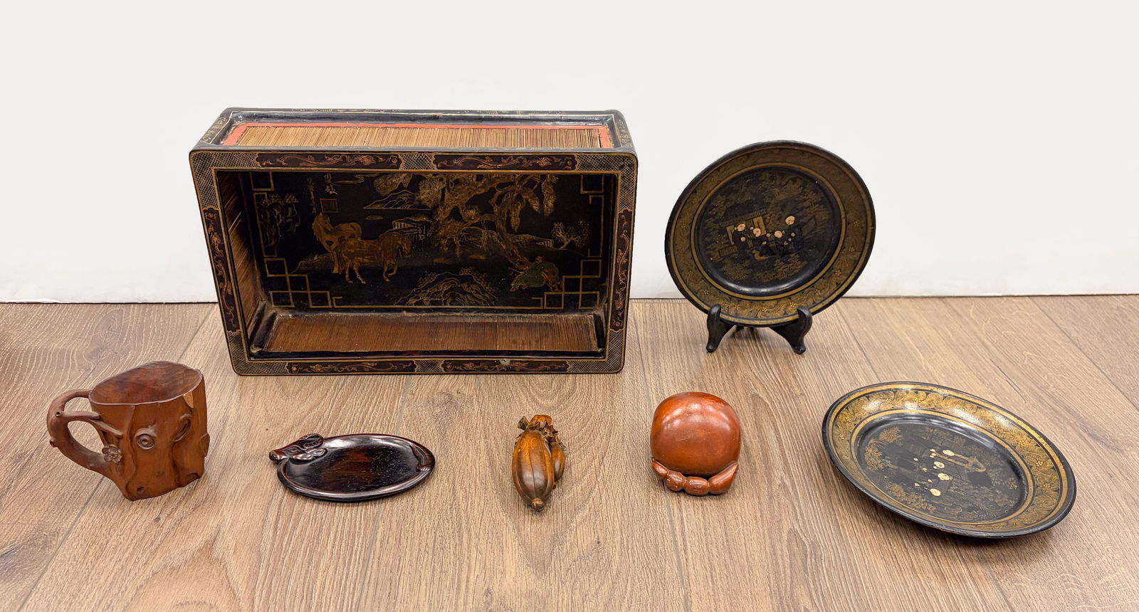 Vintage Chinese Lacquer, Wood Wares: Including a tray painted with horses, two plates painted figural scene, a wood cup carved with flowers, a wood carved gourd sculpture, a wood dish carved buffalo, and a wood sculpture carved lotus. Ap