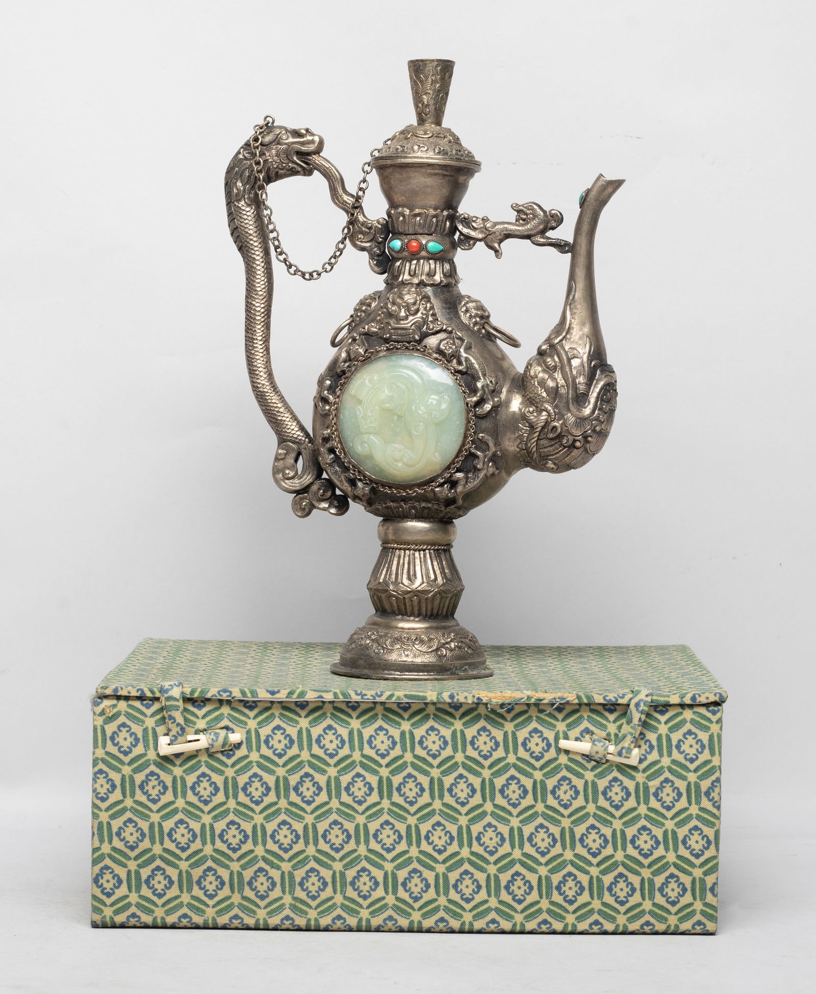 Chinese Silver Tone Pot Inlaid Stone: Of flattened pear shape rising from a splayed foot to a waisted neck, either side inlaid with a stone plaque carved with beast, the body cast with beasts and masks, the handle worked of dragon form, t