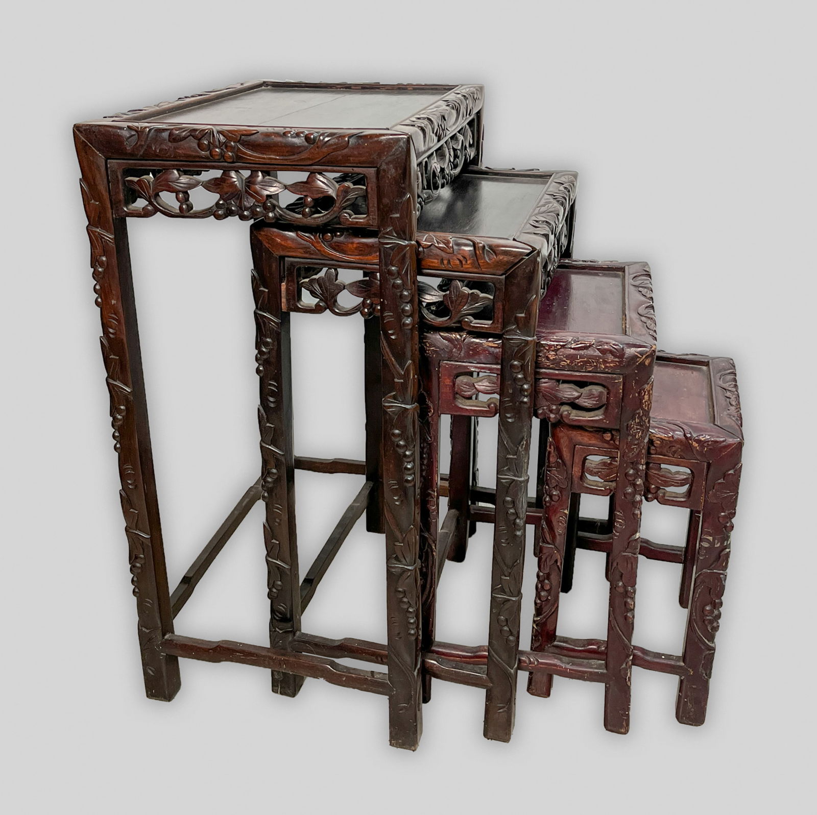 Antique Chinese Rosewood Nesting Tables: Set of four Chinese hand carved rosewood nesting tables, the edges carved with grapes. Size Approx. 19-13.5-27 inch (largest).