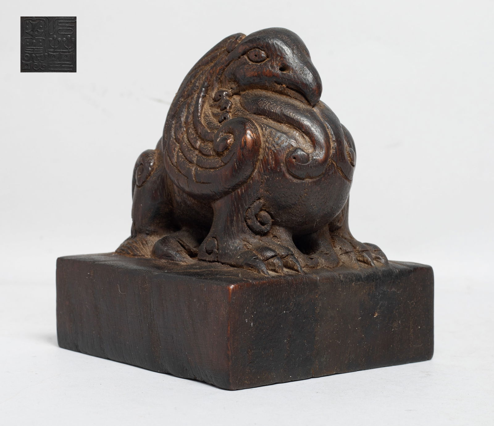 Large Chinese Bark of Agarwood Seal: Of square section, carved on the top with a mythical beast, with protruding eyes, a pointed beak and sharp claws. Approx. 155 gram, 4*4*4.8 inch. The Estate of the Store Closed Sale, Los Angeles. 2022