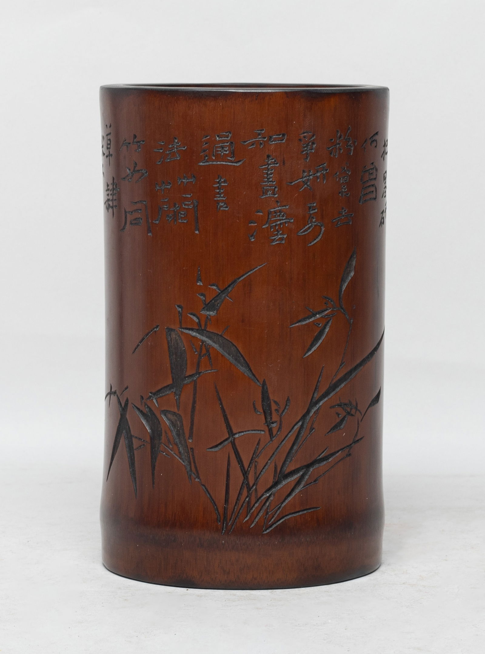 Chinese Bamboo Carved Brush Pot: Of cylindrical form, the exterior carved with orchid and inscribed with poems. Approx. 6.6*4*3.7 inch. The Estate of the Store Closed Sale, DTLA.