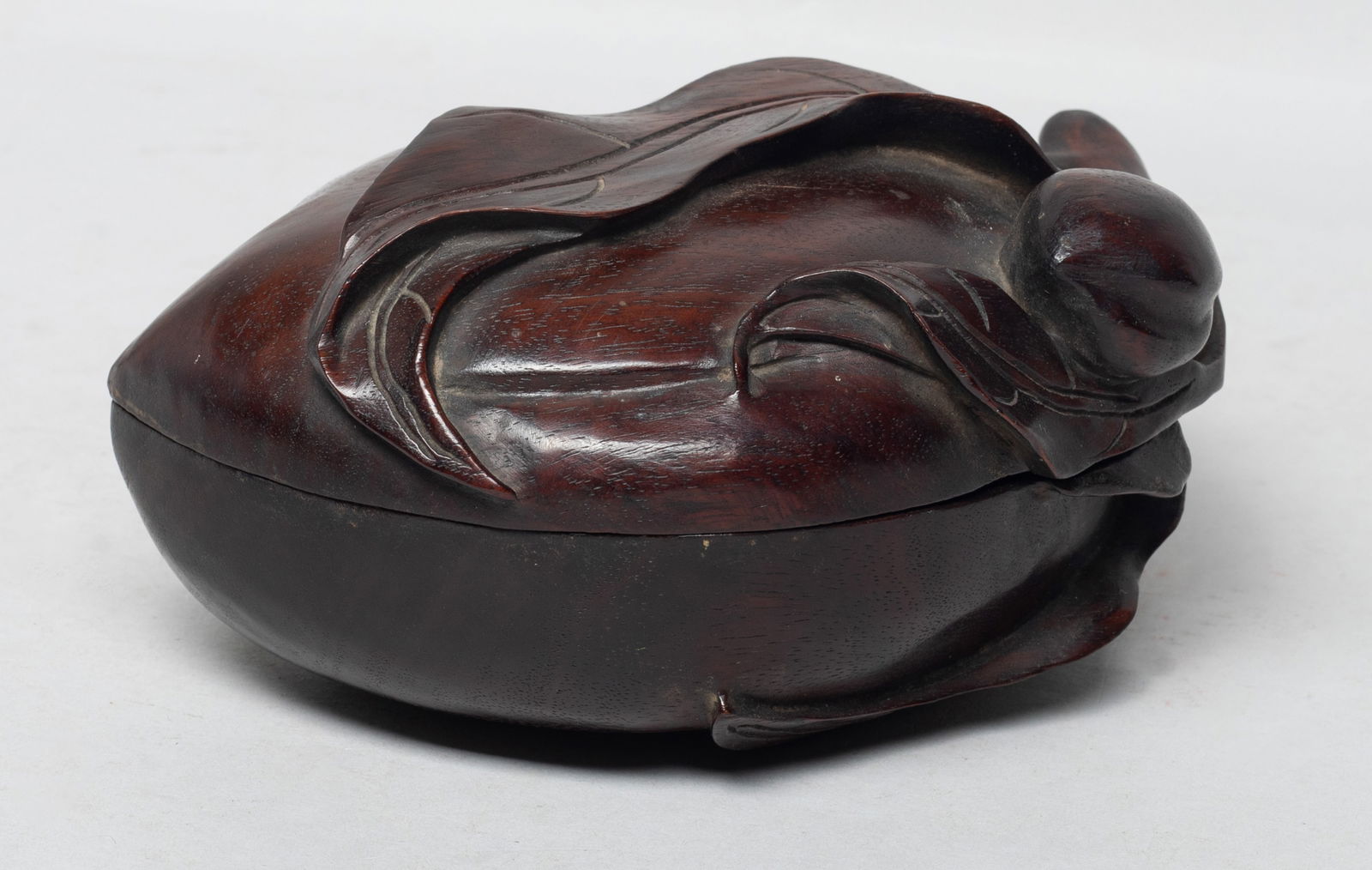 Chinese Tan Wood Carved Peach Form Box: Of peach form, with a short stem forming the handle, issuing leaves and smaller peaches. Approx. 5.7*4.3*2.7 inch. The Estate of the J & J Found, AZ, 2021.
