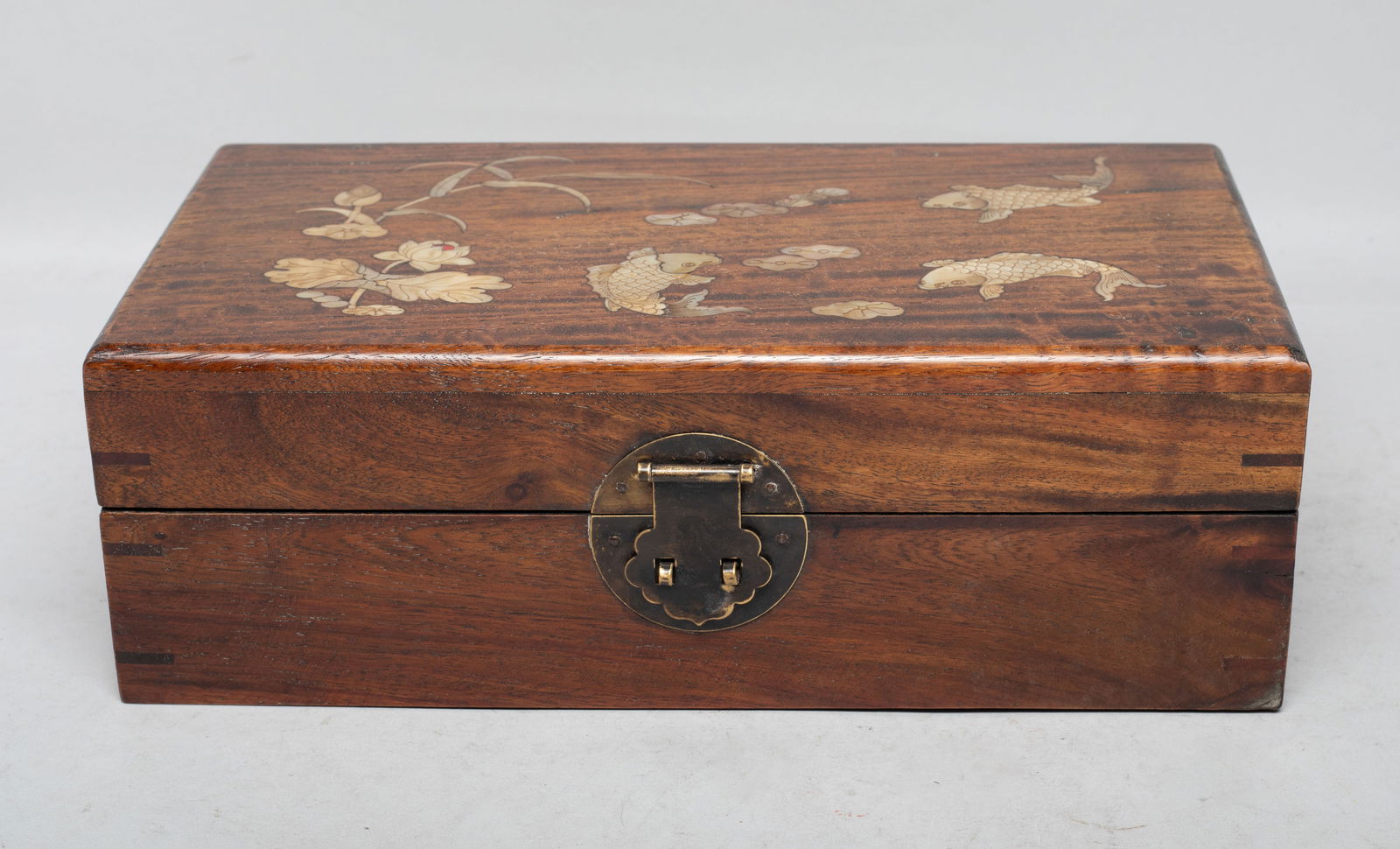 Large Chinese Wood Inlaid MOP Box: Large collectible Chinese wood box, inlaid with mother-of-pearl and carved as fish and lotus. Approx. 10.8*6*3.5 inch. The Estate of the Store Closed Sale, Los Angeles. 2022.
