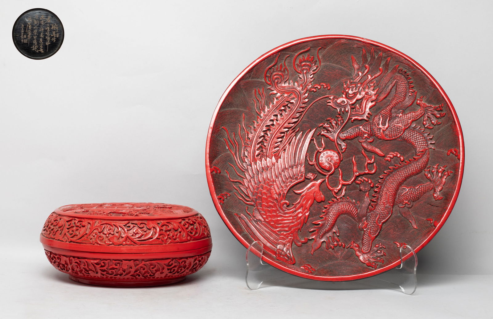 Estate Chinese Export Cinnabar Box, Plate: The plate interior carved with a dragon and a phoenix pursuing a flaming pearl over waves, the box top carved with landscape scene, the sides with meandering foliage, the bottom with inscription.