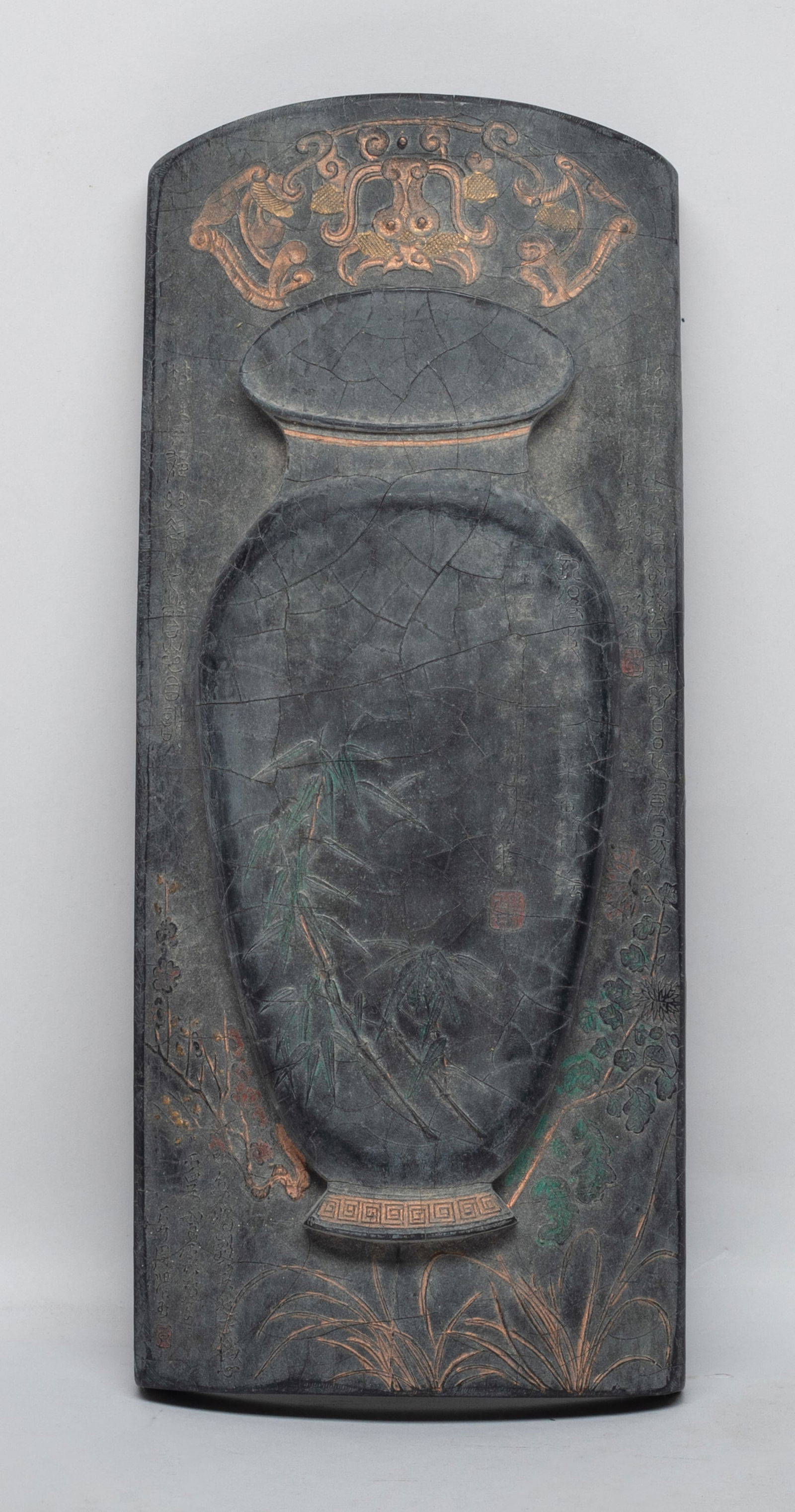 Large Chinese Writing Ink Stick: Large Chinese ink stick of arch form, the top carved with a vase, foliage, bamboo, plum blossoms, orchid, and chrysanthemum, the underside with inscription, marked with five characters on either flank