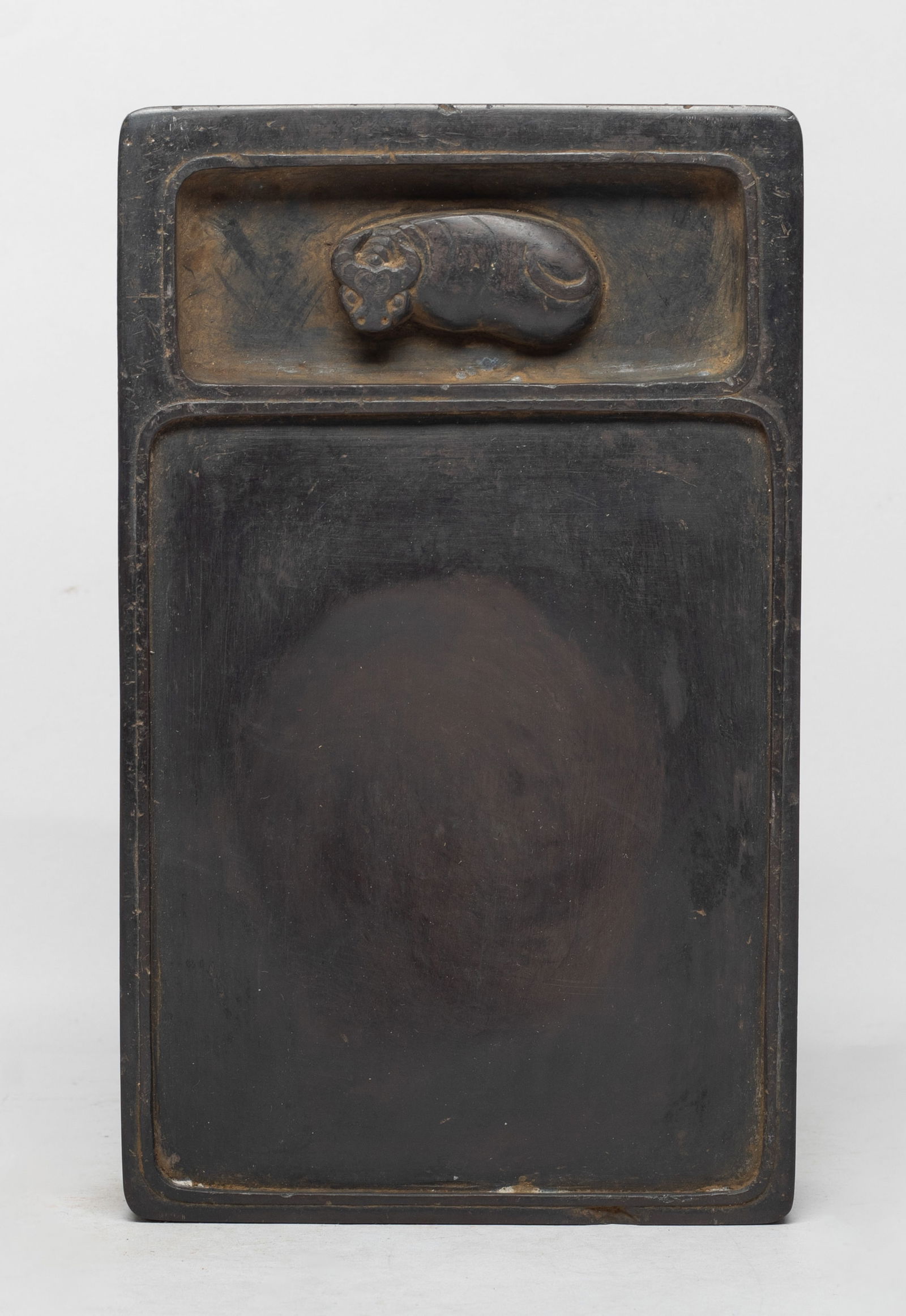 Large Chinese Carved Ink Stone: Of rectangular shape, the top side carved with a recumbent buffalo, incised with poems and two marks on the left side. Approx. 8*5*2 inch. The Estate of the Miura, Ventura, CA, 2020.