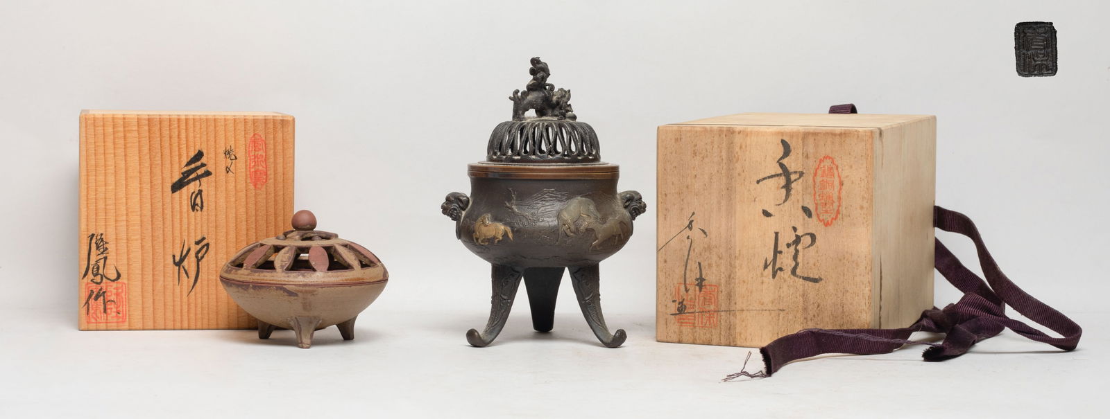 Two Vintage Japanese Metal & Clay Censers: The clay censer molded of flower form, th metal censer cast with horses in mountain landscape, with two faux-ring mask handles and three spreading legs, the openwork lid with a beast finial, with two