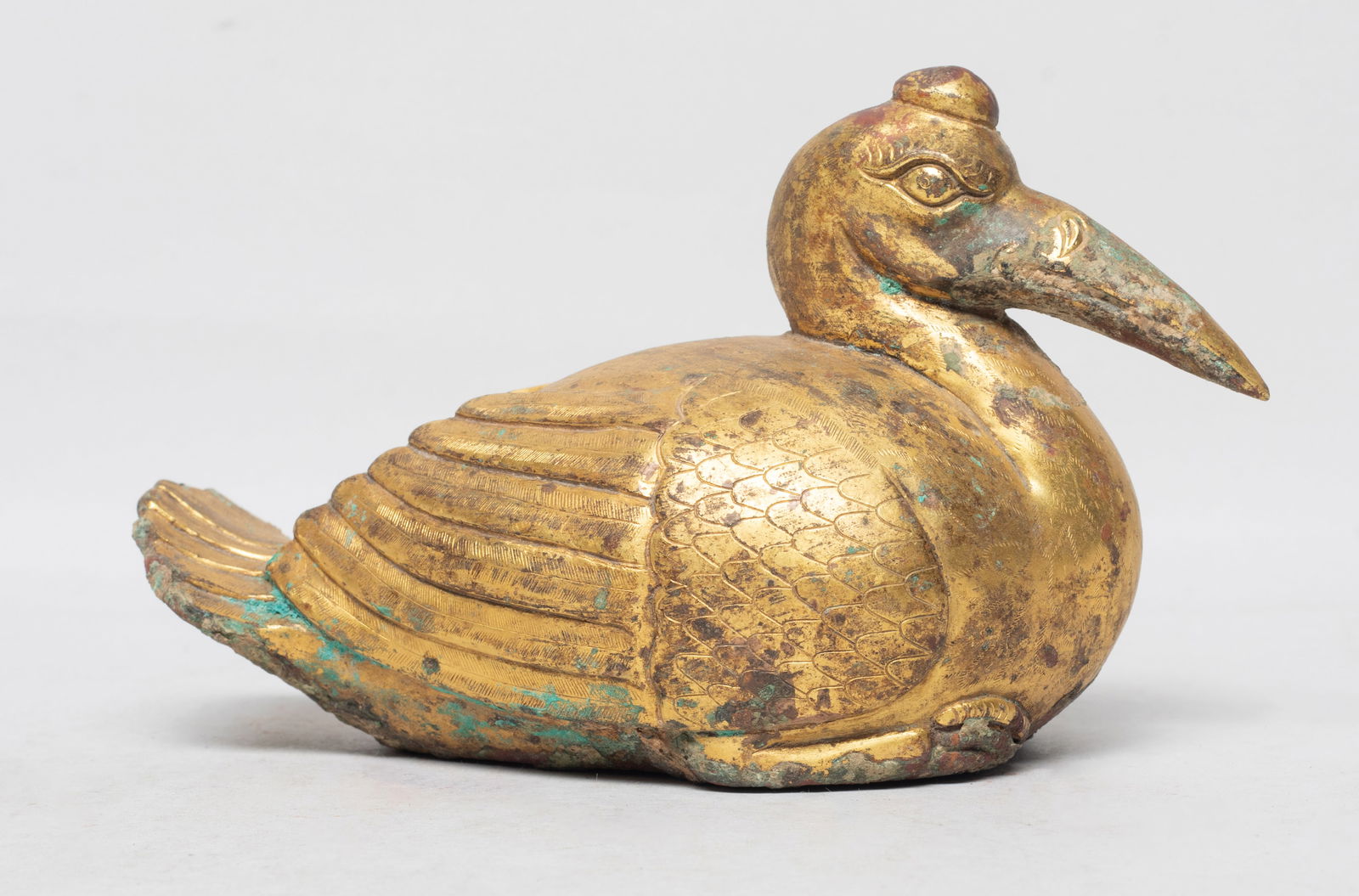 Chinese Gold on Bronze Sculpture: Chinese hollow gold on bronze sculpture of recumbent bird form, with bulging eyes, a protruding beak, and a raised crest. Approx. 6*3.7*2.8 inch. The Estate of the J. W Town. HK. 2003.