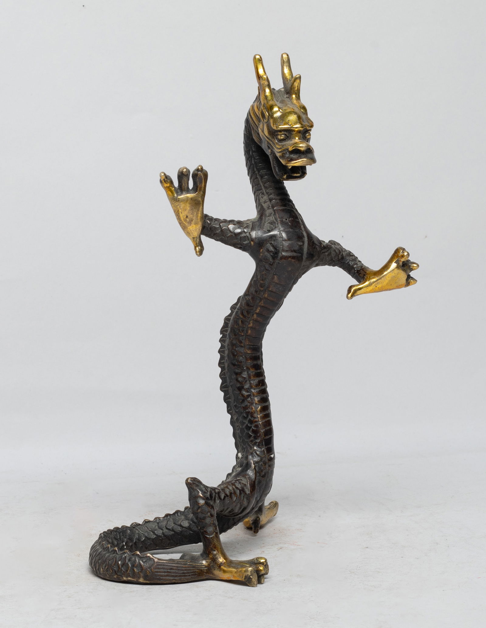 Chinese Bronze Sculpture of Dragon: Chinese bronze cast table sculpture of sinuous four-clawed dragon form. Approx. 9.4*5.2*3.5 inch. The Estate of the E Los Angeles, 2023.