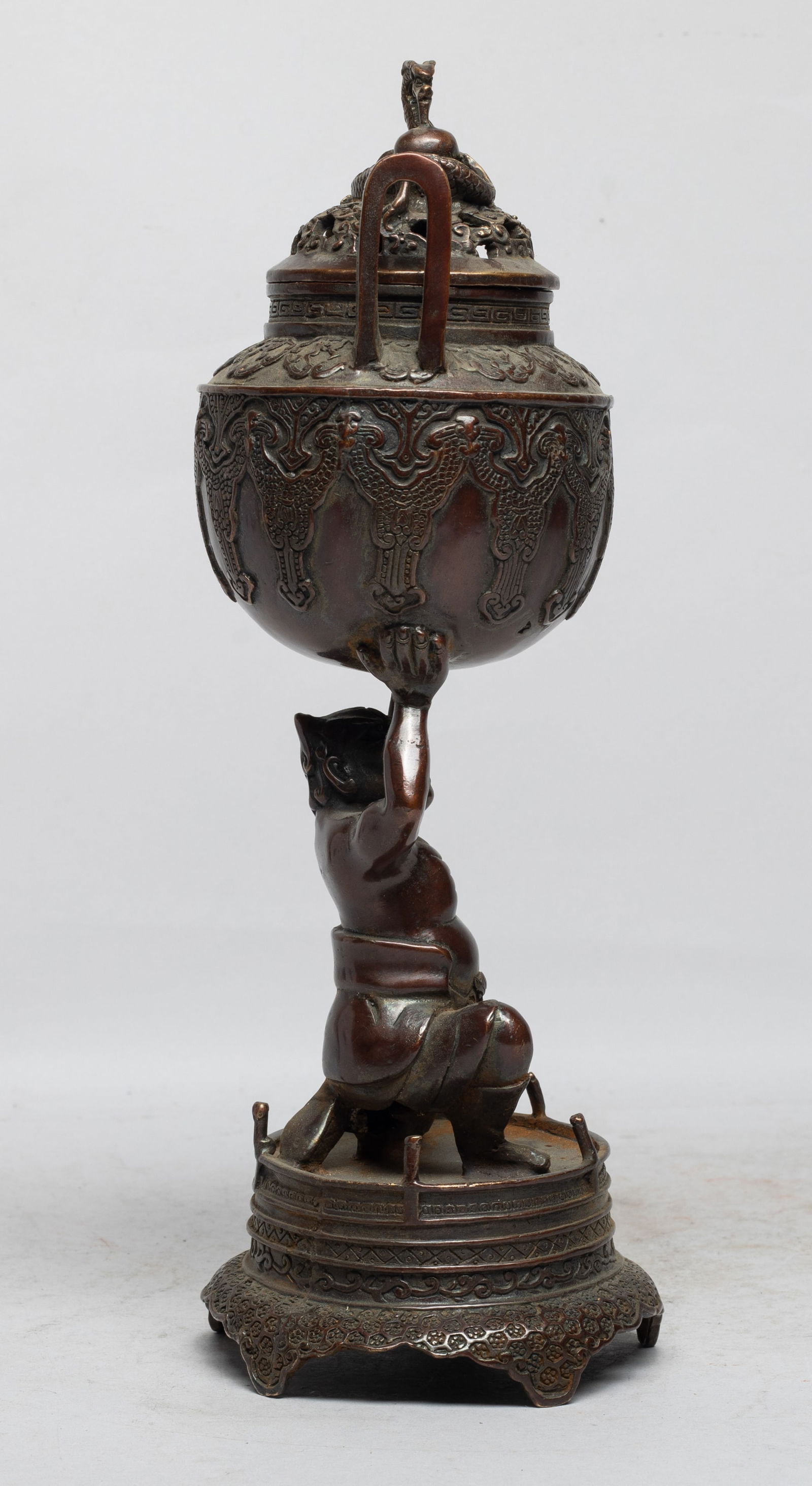 Rare Chinese Bronze Covered Censer: Cast as a kneeling figure supporting a censer, the censer body carved with traditional motif, the openwork lid cast with a dragon sinuous above clouds. Approx. 11.3*3.6 inch. The Estate of the E Los A