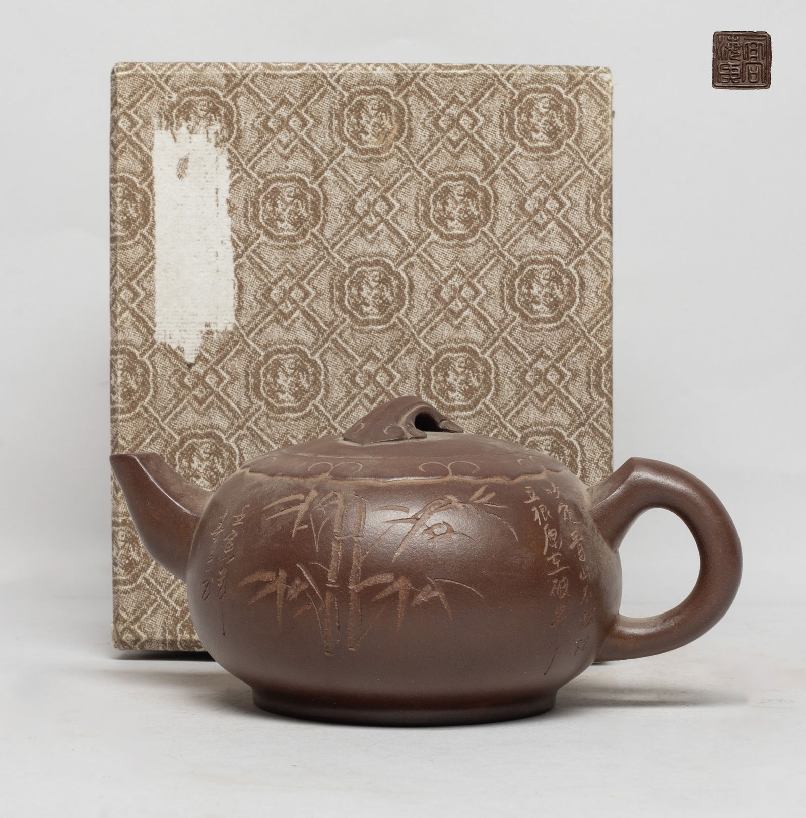 Vtg. Chinese Export Yixing Zisha Tea Pot: The zisha tea pot body incised with bamboo and inscribed with related passages, the lid interior with two marks, the bottom with seal mark, with box. Approx. 6.2*4.3*3 inch (w/o box). The Estate of th