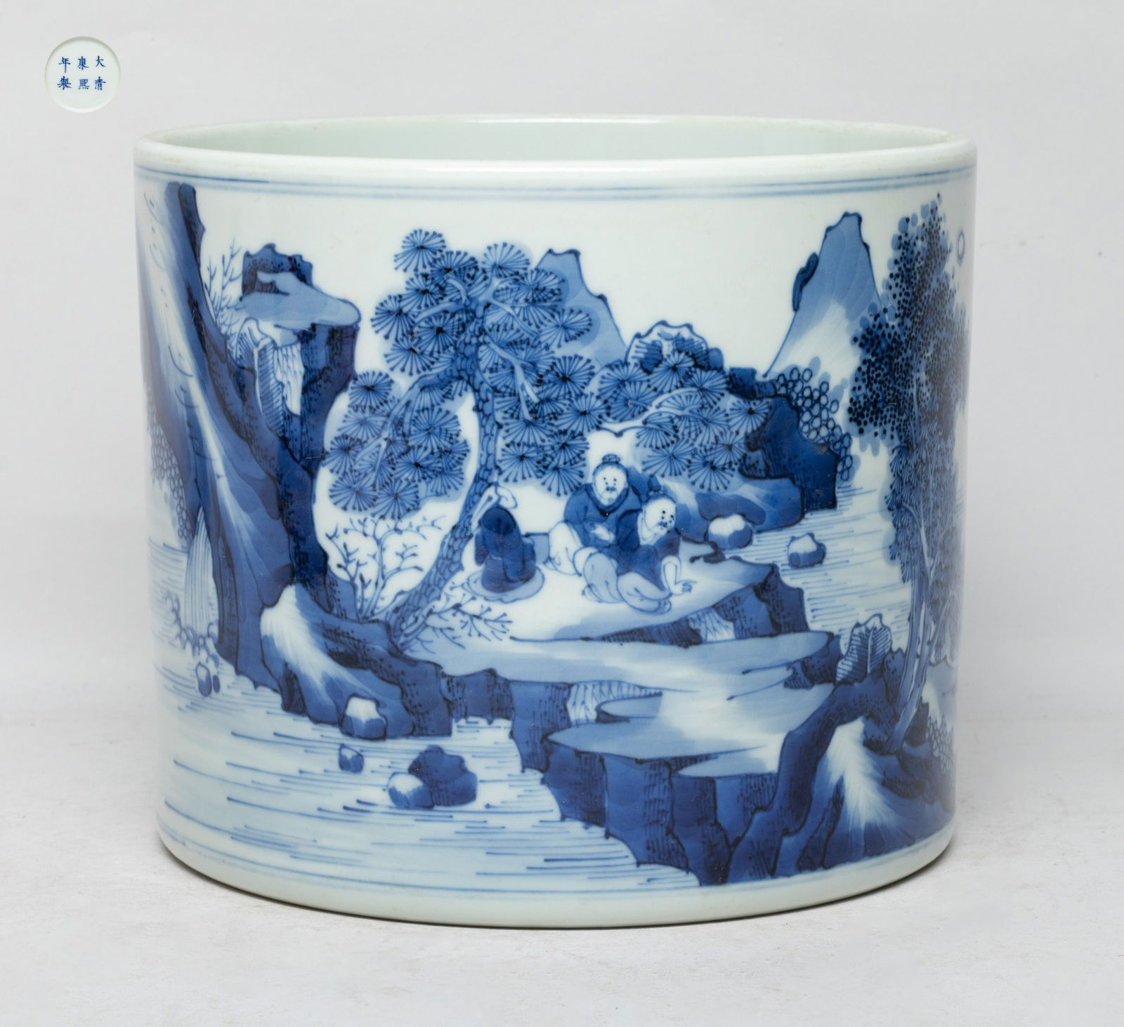 Large Chinese Blue & White Porcelain Brush Pot: Of cylindrical form, the exterior painted with continuous landscape scene, with three figures sitting under a pine tree, two figures walking at riverbank, and one figure on a boat, the bottom marked w