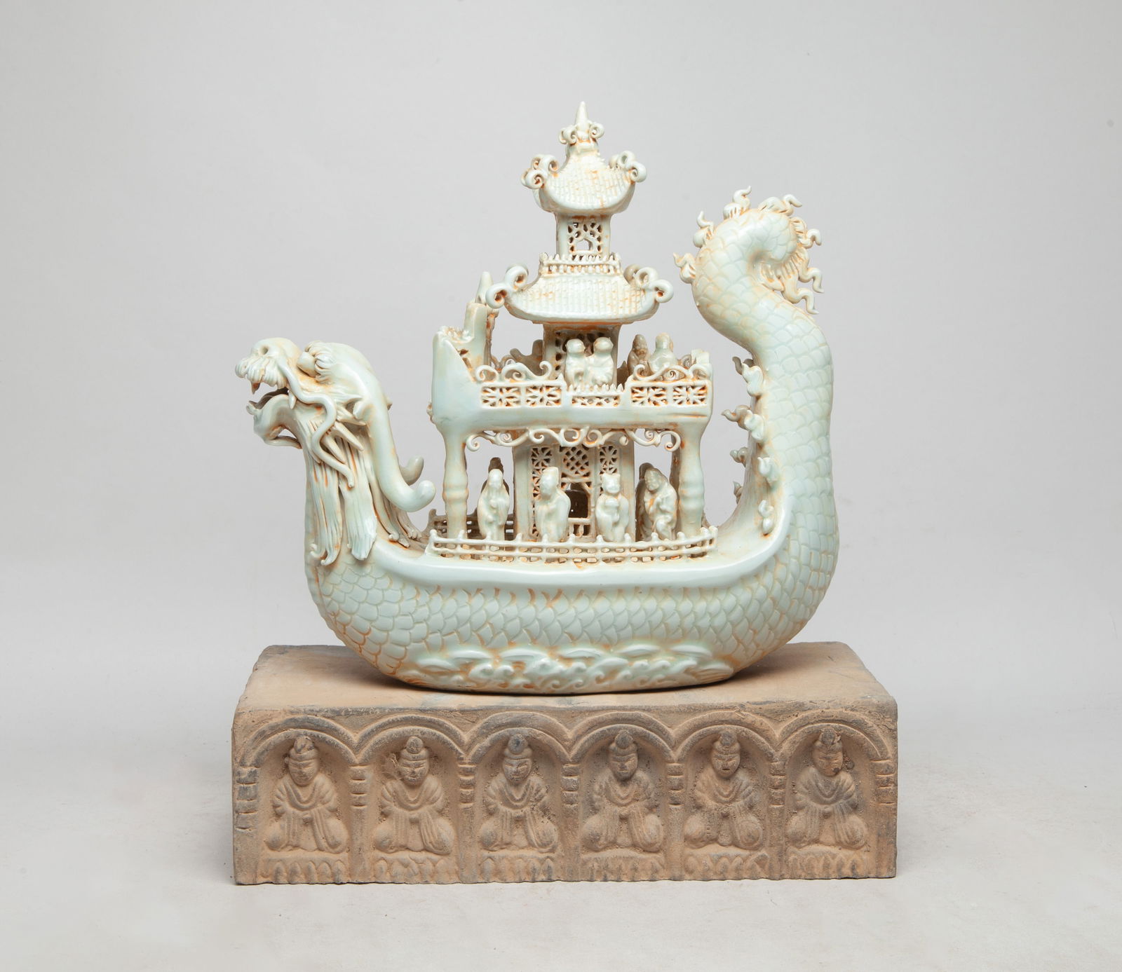 Korean Porcelain Boat w/ Stone Base: The fabulous craft fitted with a dragon's head on the prow, the dragon body supporting pillared pavilions peopled with tiny figures, with a stone base. Approx. 10*10.6*4 inch (w/o base).