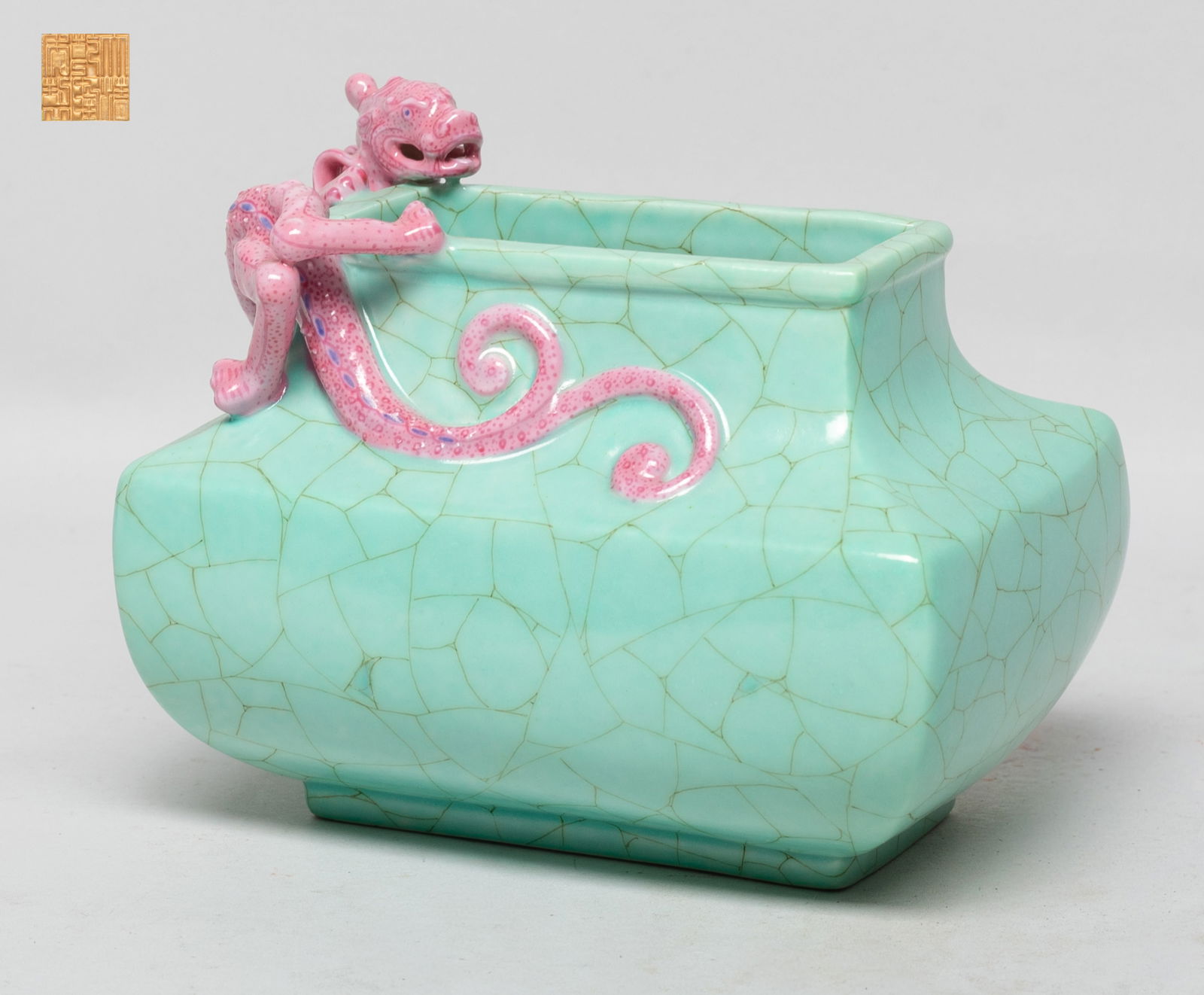 Chinese Flambe Glazed Porcelain Censer: Of rectangular section, the censer exterior and interior neck covered in soft turquoise glaze suffused with a matrix of crackles, carved in high relief with a chilong around the mouth, the dragon body