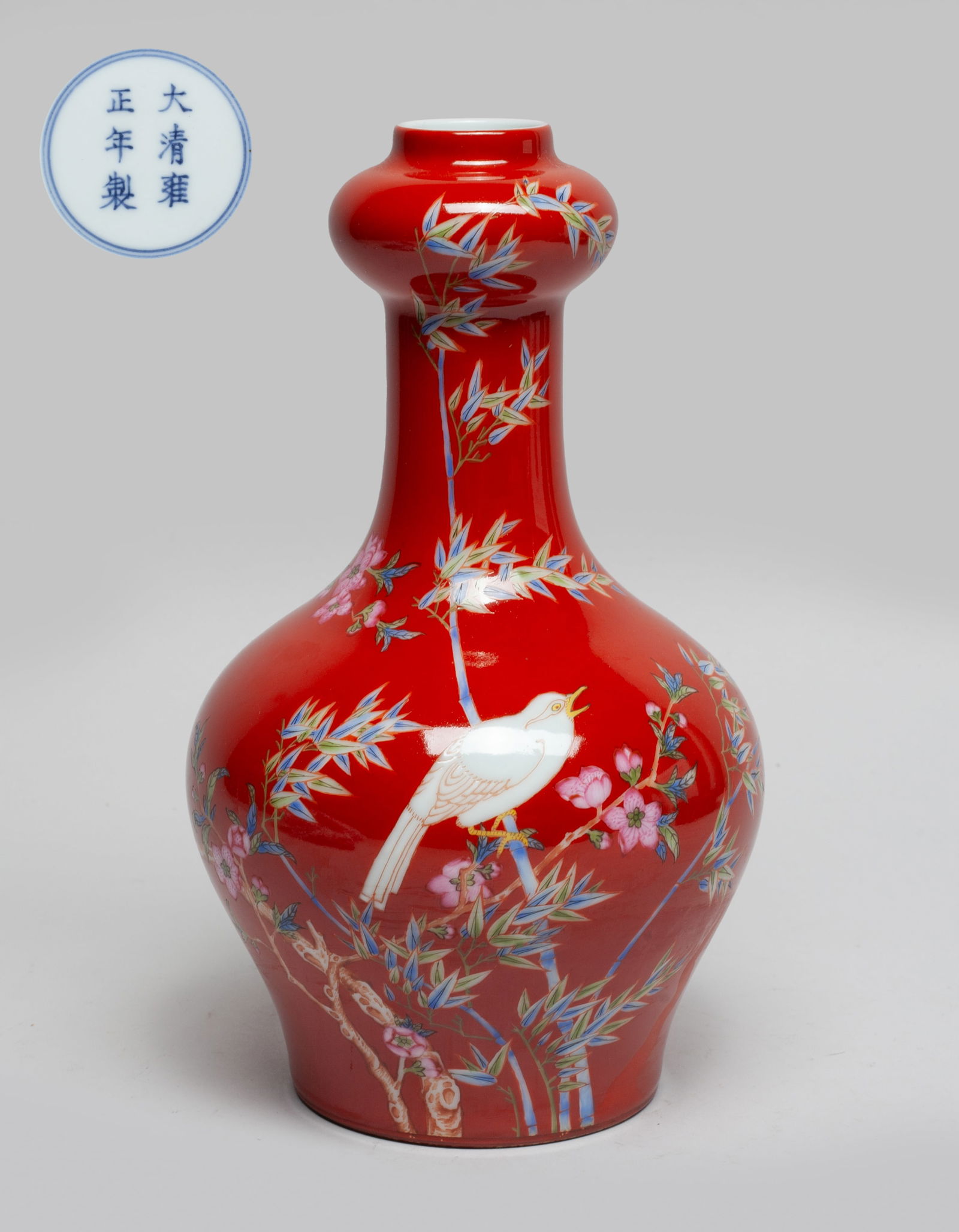 Chinese Export Enameled Porcelain Vase: The vase exterior decorated with a pair of birds among flower tree branches and bamboo on red glazed ground, the bottom marked with six characters enclosed in double circles. Approx. 8.5*4.8 inch. The