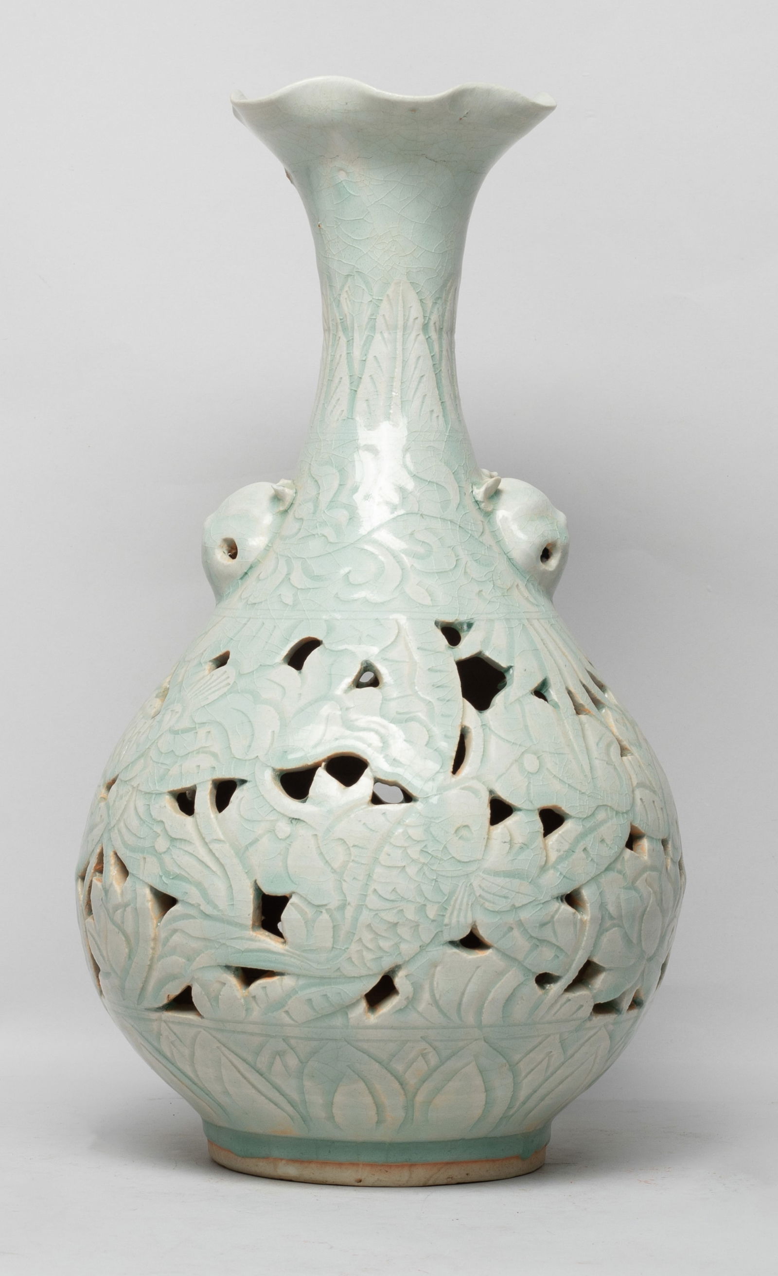 Estate Large Chinese Porcelain Vase: The pear shaped body rising from a short foot to a waisted neck and an undulating rim, flanked by two raised beast masks, the body reticulated with fish swimming amidst louts, under bands of leaves an