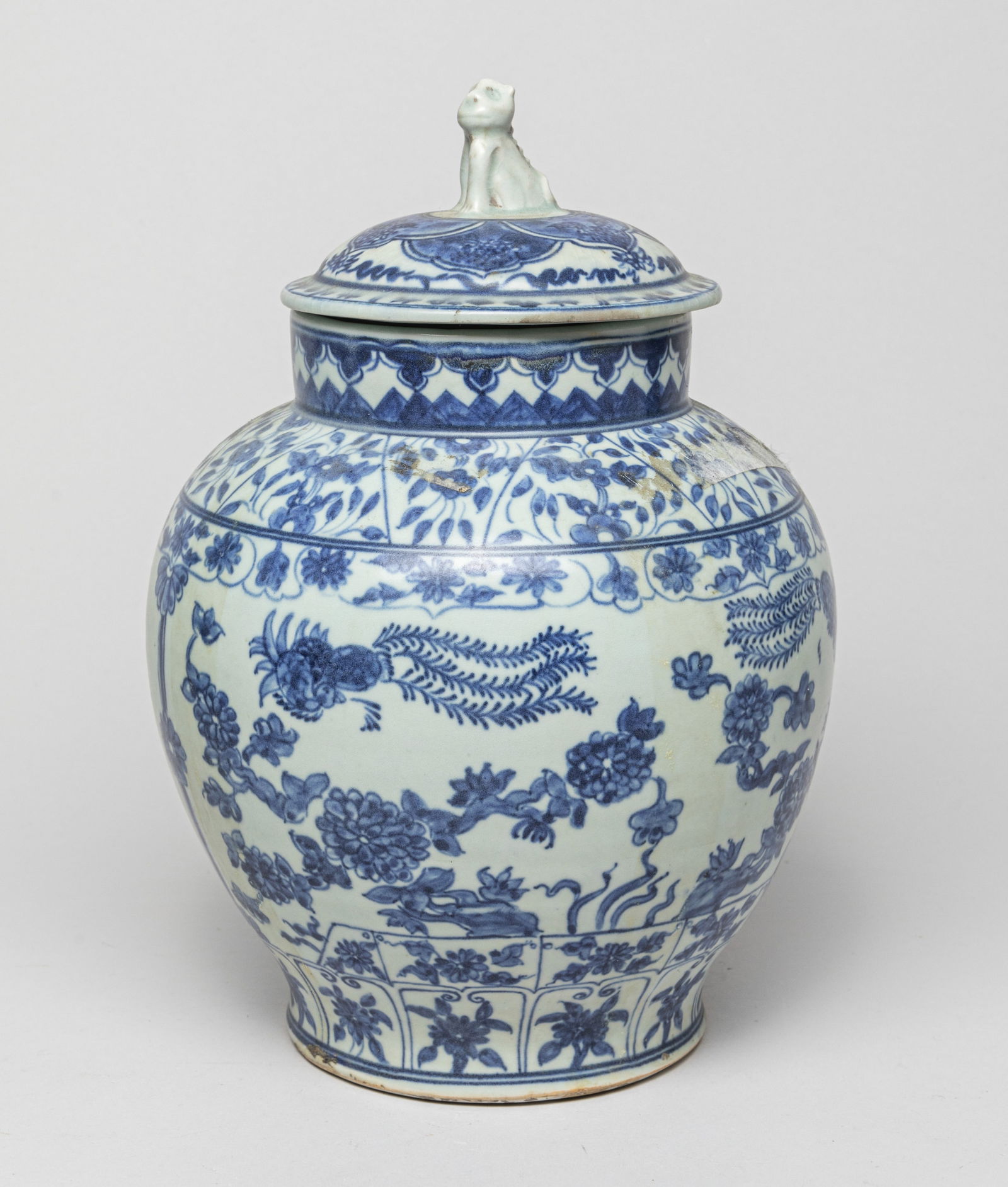 Chinese Lg Shipwreck Porcelain Jar: The ovoid body surmounted by a short neck, the exterior painted with phoenixes amidst blossoming flowers, the cover with a beast as a finial, the glaze stopping at the base. Approx. 10.8-7.4 inches