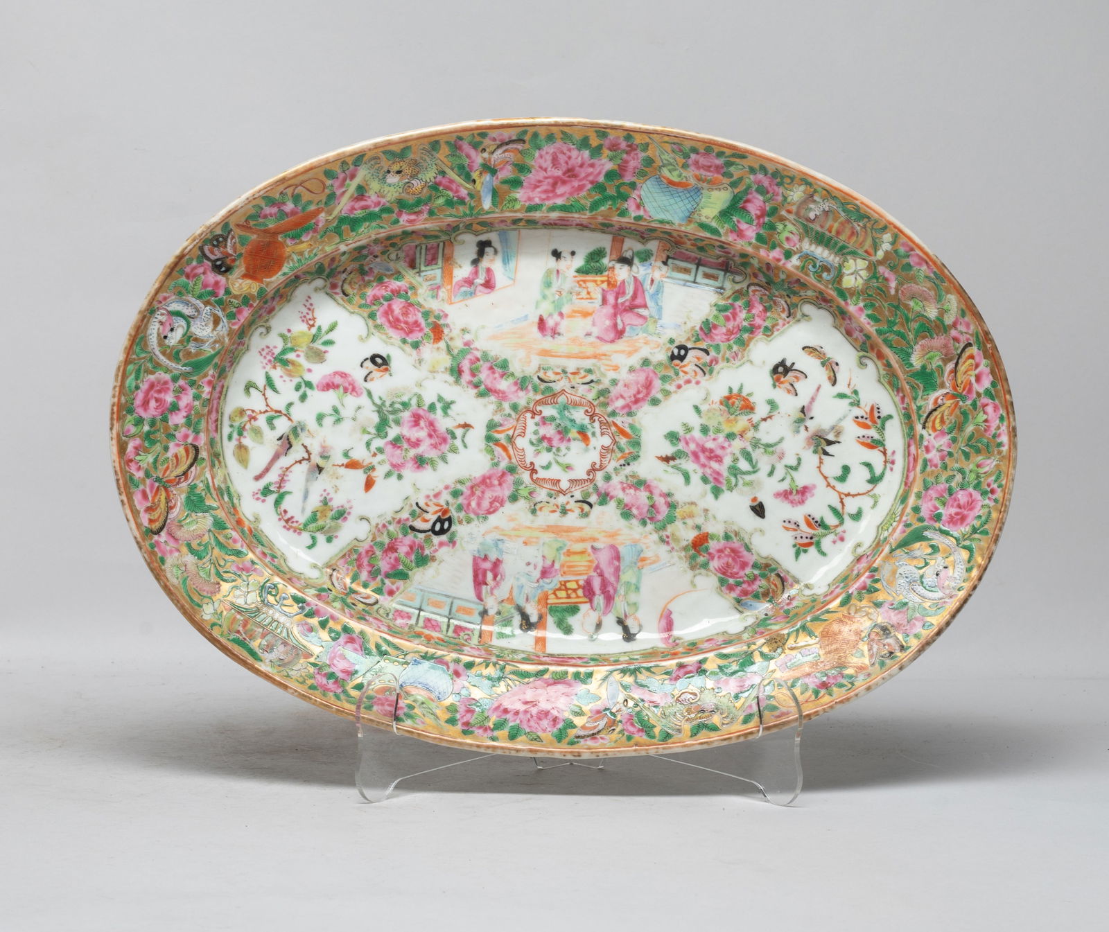 Large Chinese Famille Rose Porcelain Plate: Of oval shape, the interior enameled and painted with panels of butterflies, birds and flowers, or panels of figural scene, the rim with glowers, fruits, butterflies, and dragons. Approx. 14.5*10.2 in