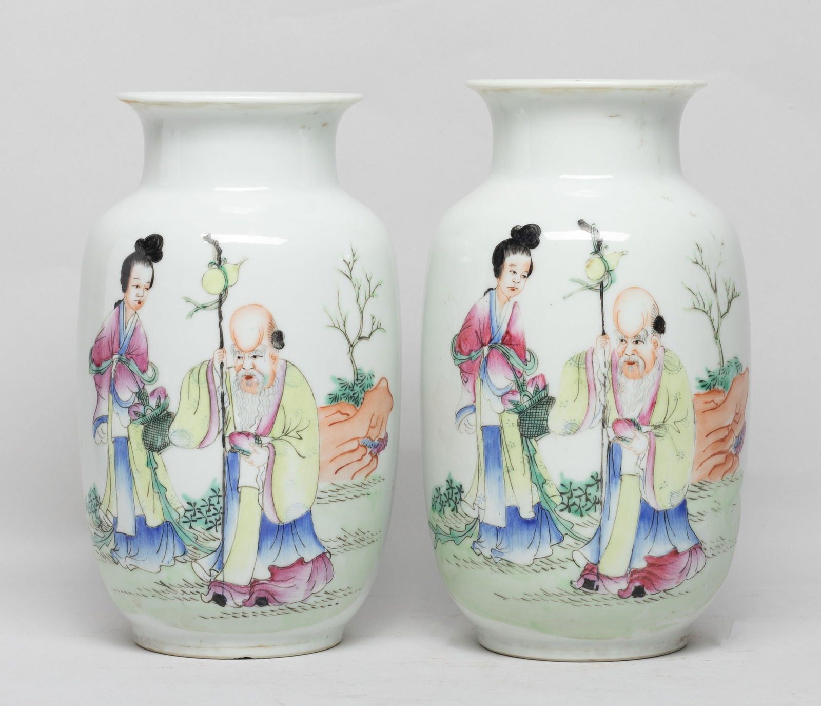 Two Chinese Famille Rose Porcelain Lamp Vases: Each vase painted with Shoulao holding a peach in left hand and right hand holding a stick suspended with a gourd, and a female carrying a flower basket, the bottom pierced with a circular aperture. A