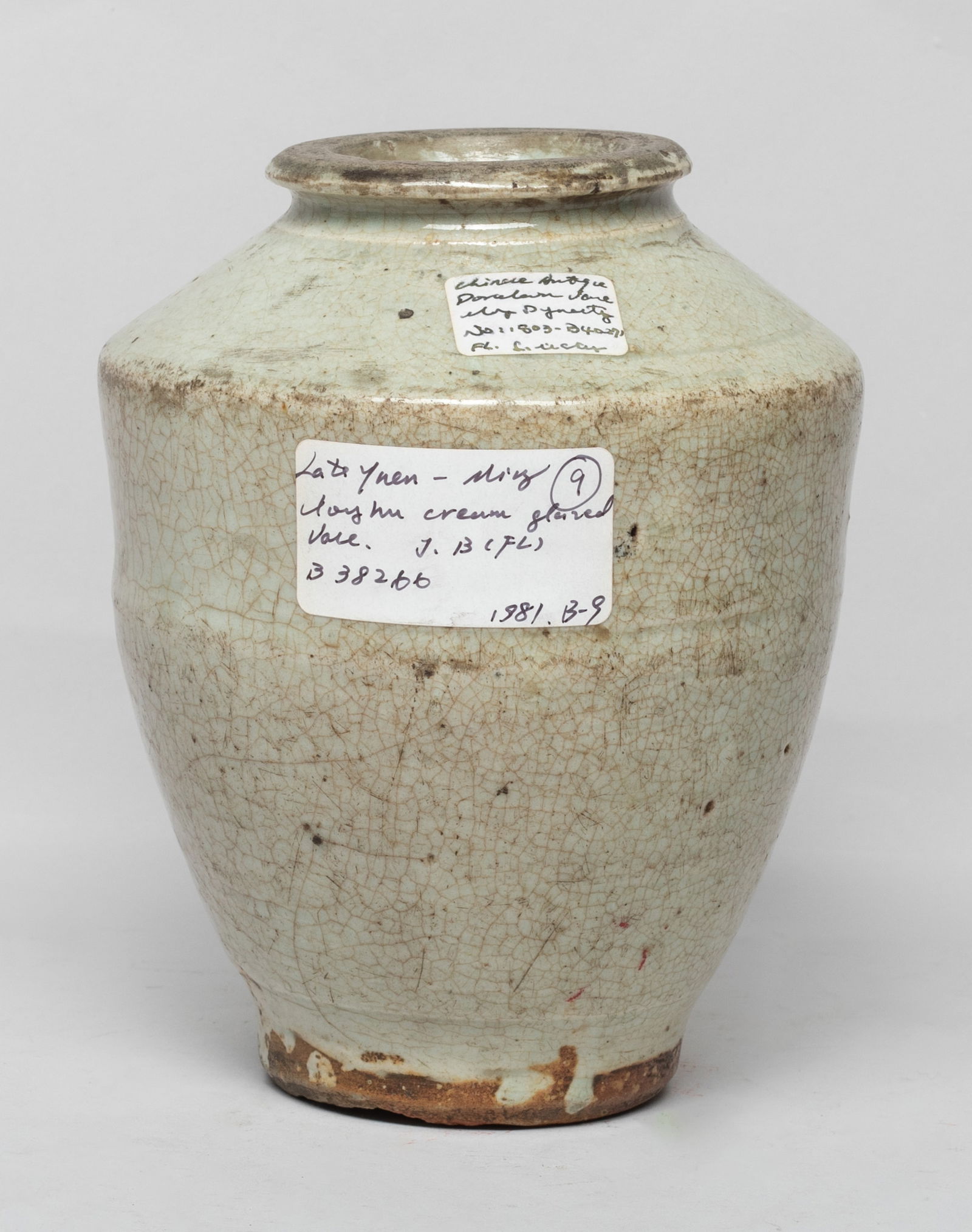 Chinese Cream Glazed Porcelain Vase: The tapered body rising to an angled shoulder and an everted rim, the exterior covered crackled and mottled pale sea green glazed. Approx. 7*5.5 inch.