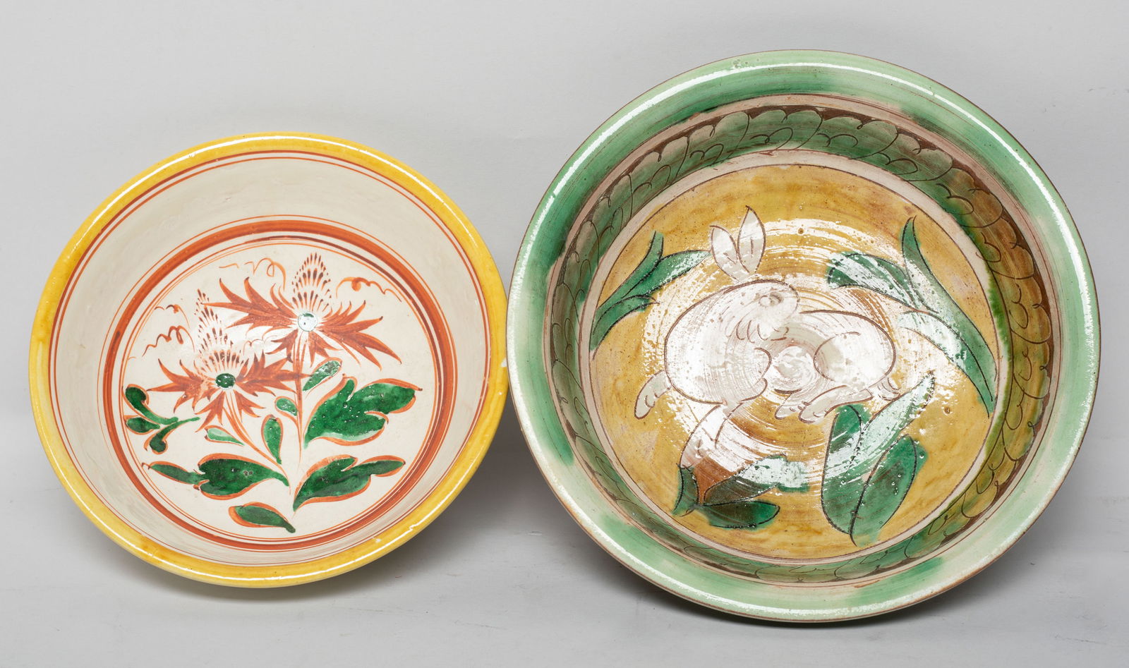 Two Chinese Glazed Porcelain Bowls: One bowl interior painted with a rabbit and leaves in white, yellow and green colors, the other bowl interior painted with flowers in green and red colors on creamy ground. Approx. 6.6*2.2 inch (large