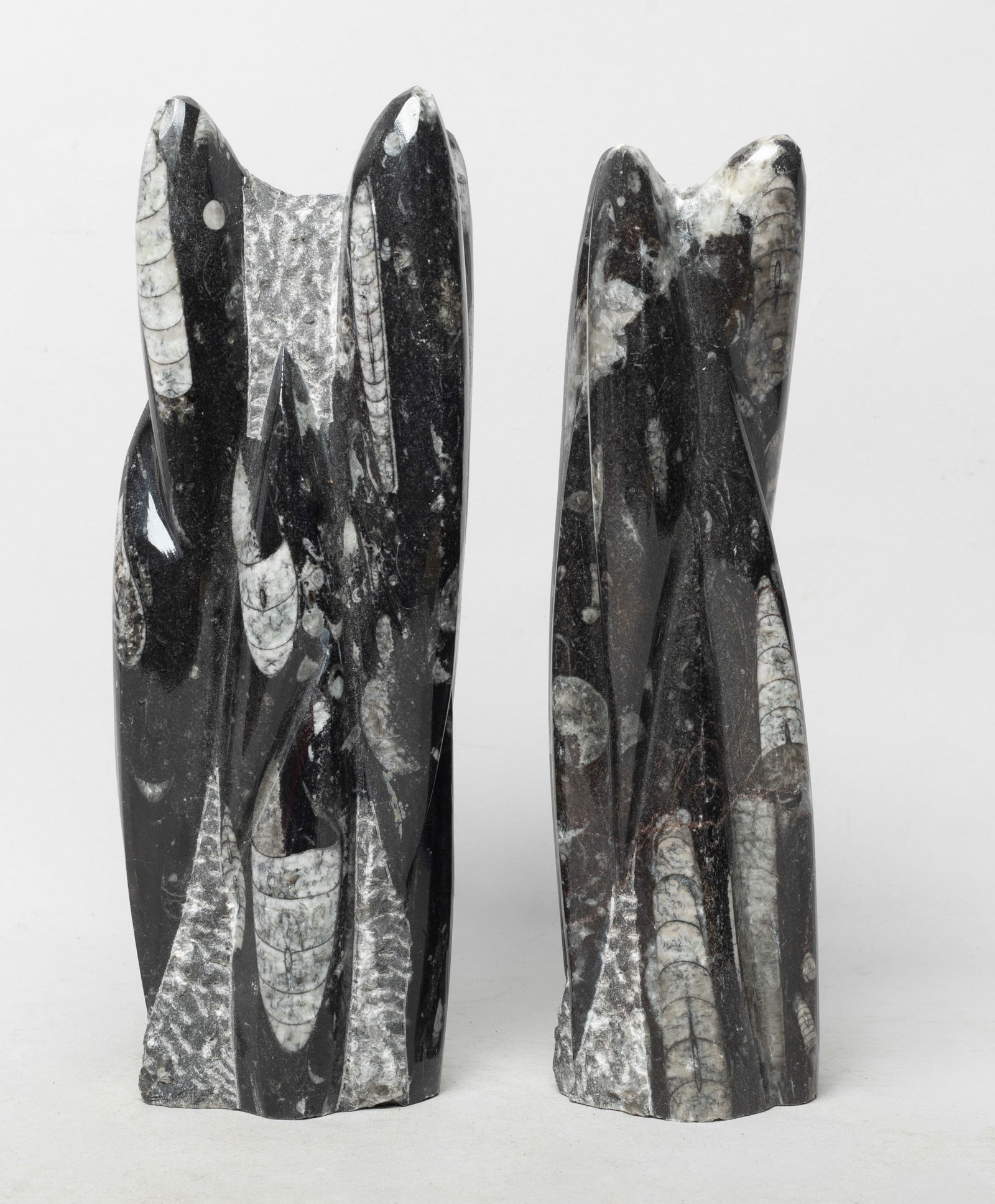Two Tall Fossilized Stone Table Sculpture: Two fossilized stone carved table sculptures. Approx. 8.7*3*2.2 inch (larger).