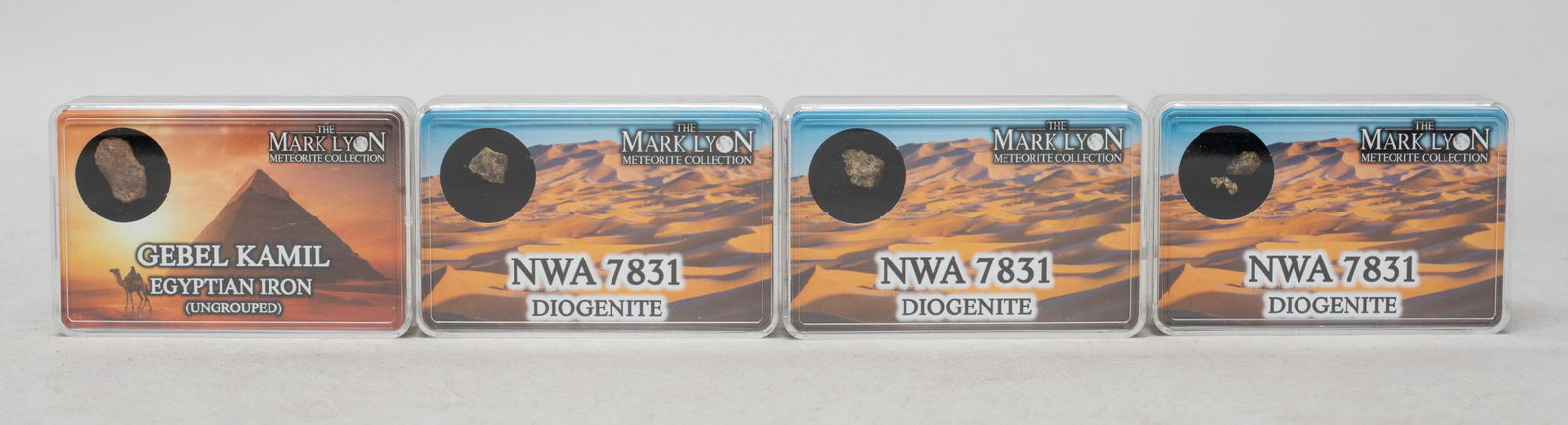 Collectible Set Meteorite Stone: Set of four meteorite stone pieces, with cases. Size varies.