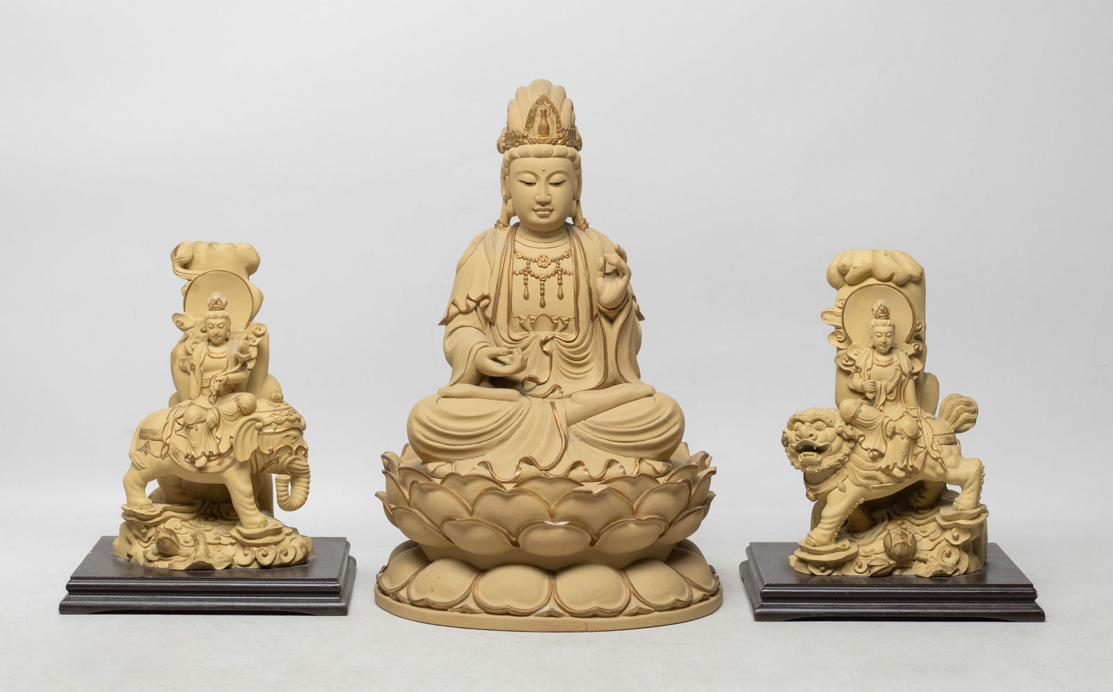 Three Vintage Chinese Export Sculptures Buddha: Set of three Chinese Buddha sculptures, one molded as Buddha seated on a waisted lotus base, the hands in elegant mudra, one Buddha seated on an elephant, the other seated on a lion. Approx. 10.4*6.8*