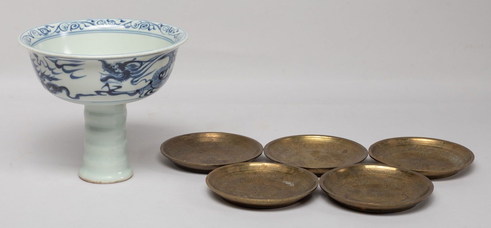 Chinese Export Porcelain Tall Cup & Brass Dishes: The tall cup exterior painted with a dragon pursuing a flaming pearl amidst clouds, the interior centre with a similar flaming pearl, and five brass dishes, each interior incised with delicate foliage