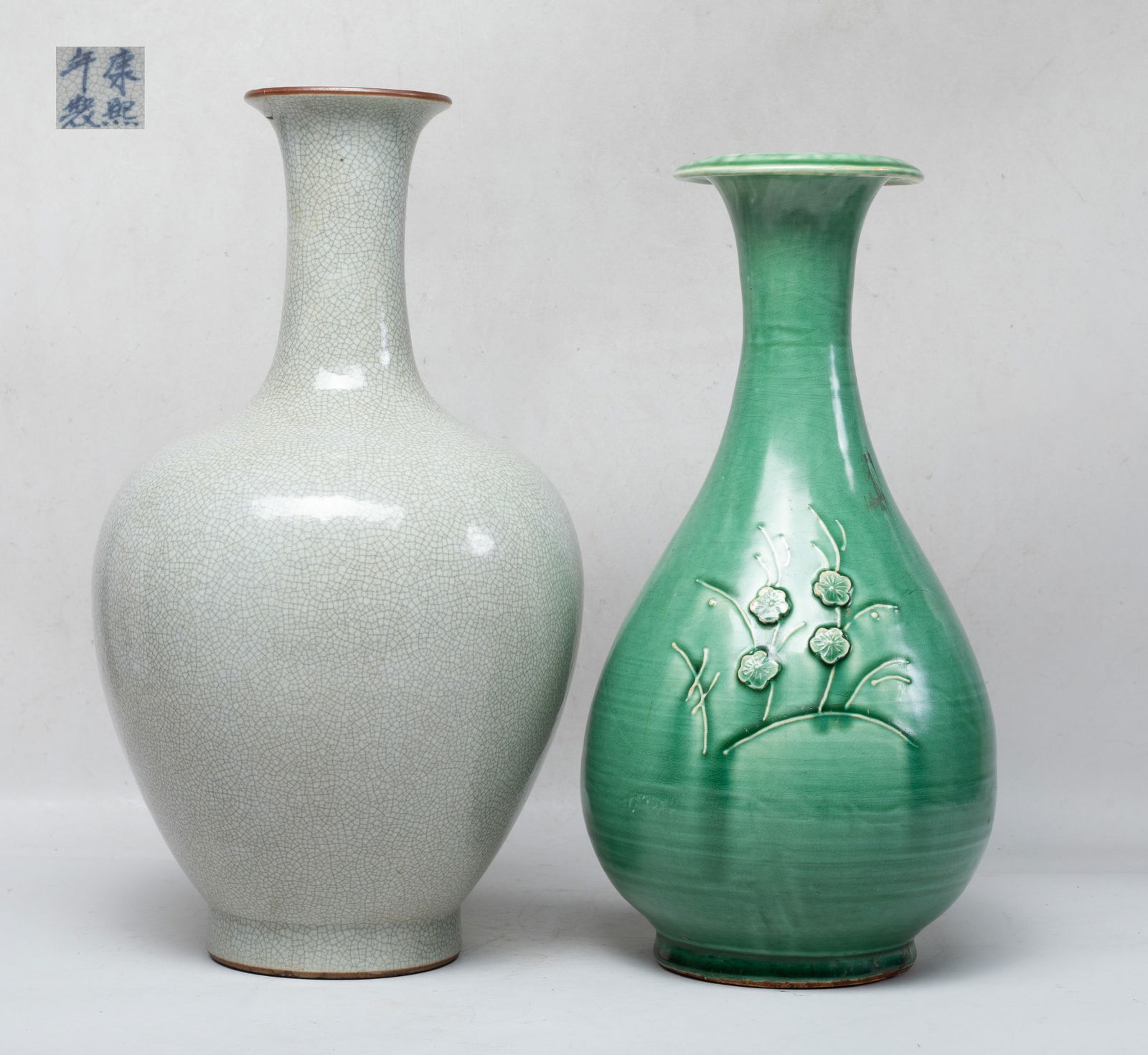 Two Vintage Chinese Export Porcelain Vases: One vase overall covered with crackled pale gray glaze, the bottom marked with four characters, the other vase covered with crackled green glaze, carved with flower stems. Approx. 13.7*7.7 inch.