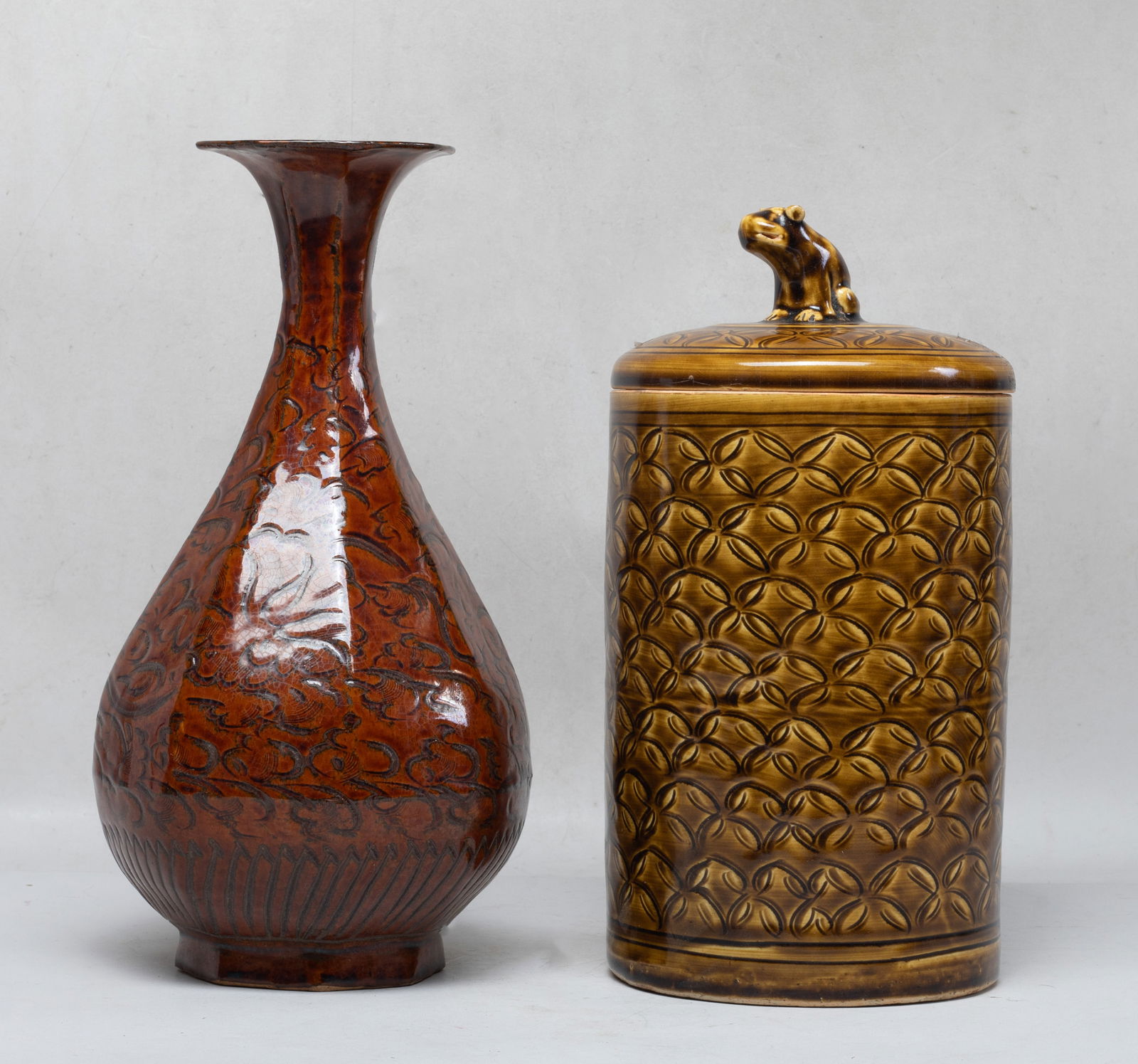 Estate Chinese Salt Glazed Stoneware: The covered jar of cylindrical form, the exterior incised with continuous floral motif, surmounted with a crouching beast as finial, applied with brown glaze, the vase exterior incised with dense foli