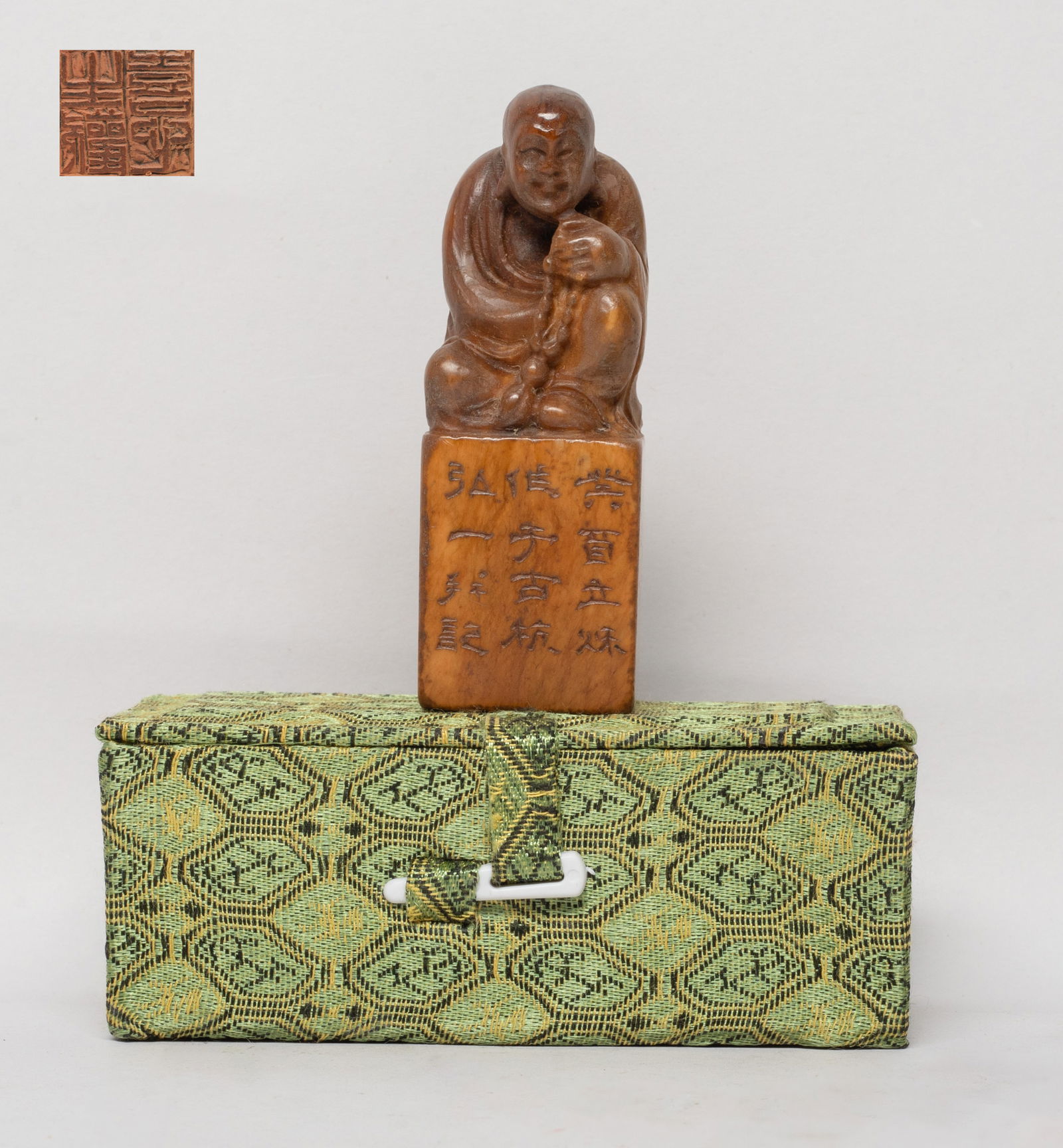 Chinese Rich Yellow Stone Seal: Of square section, the top surmounted with a seated Buddha, his left hand holding prayer beads, one side with inscription, with box. Approx. 3.2*1.17*1.1 inch (w/o box).