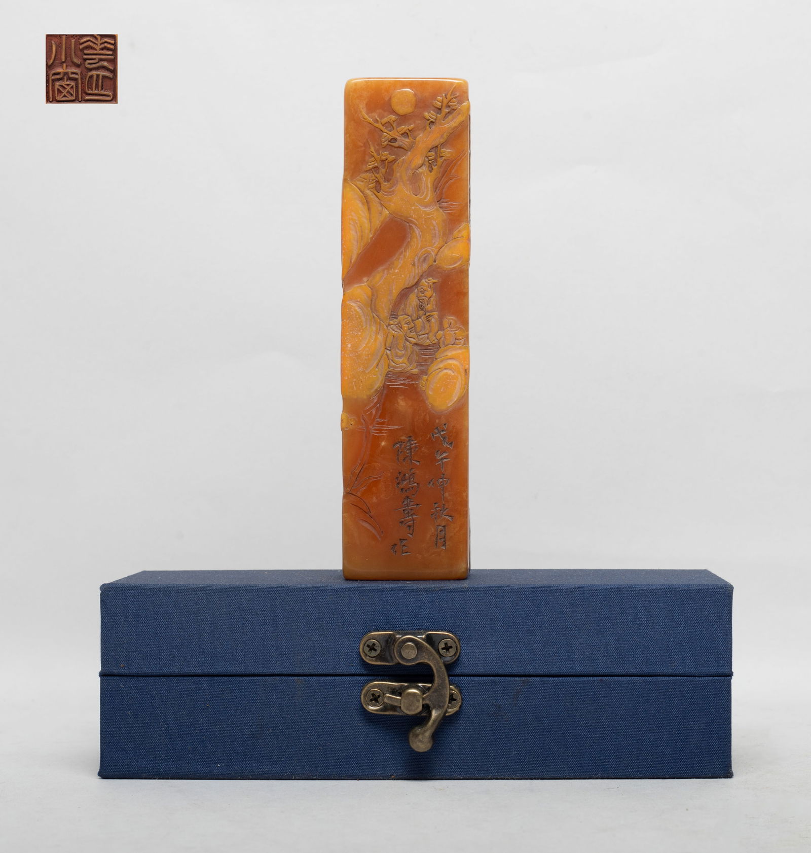 Tall Chinese Shoushan Stone Seal: Of tall square section, the sides carved with two scholars under a gnarled tree among mountains, with box. Approx. 5.57*1.4*1.4 inch.