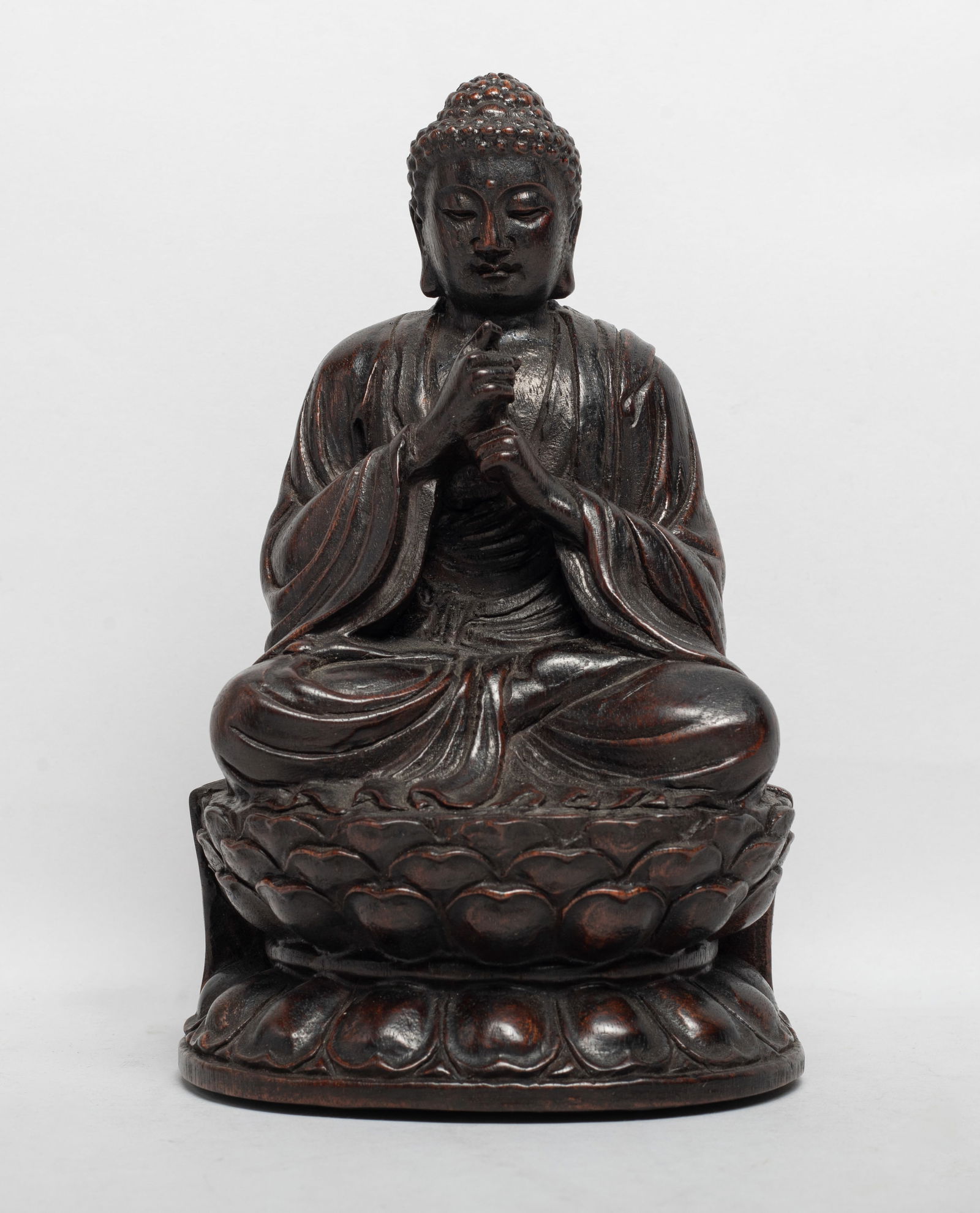 Estate Chinese Wood Sculpture of Buddha: The Buddha carved seated in dhyanasana on a double layered lotus throne, the hands in vajra mudra, the meditative face with serene expression. Approx. 7.6*4.7*4 inch.