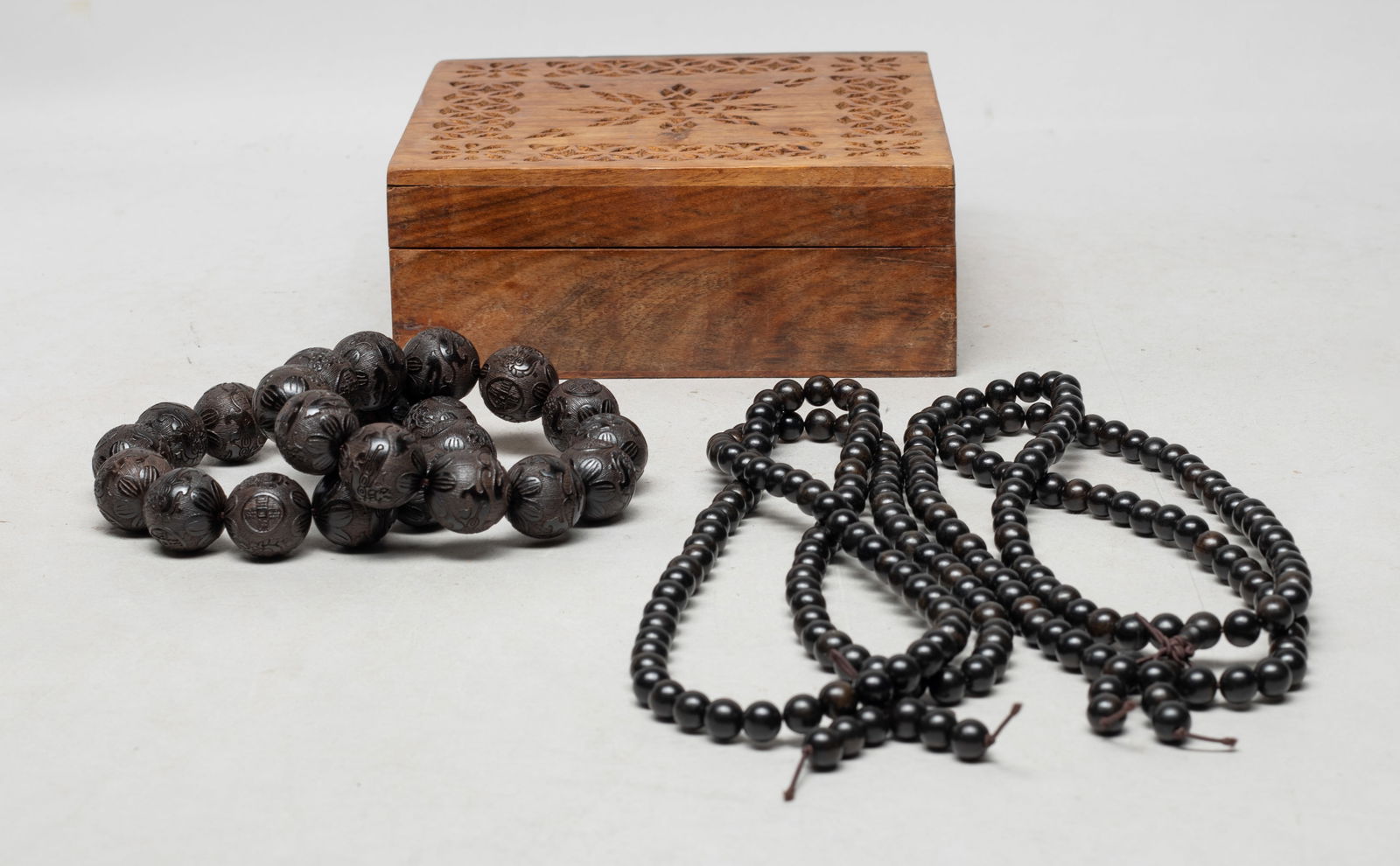 Collectible Chinese/ Asian Agarwood Prayer Beads: Including two agarwood bead necklaces, and two strings of agarwood prayer beads carved with beasts and coins, with an openwork wood box. Approx. 186 gram (total wood weight), 32 inch L (necklace size)