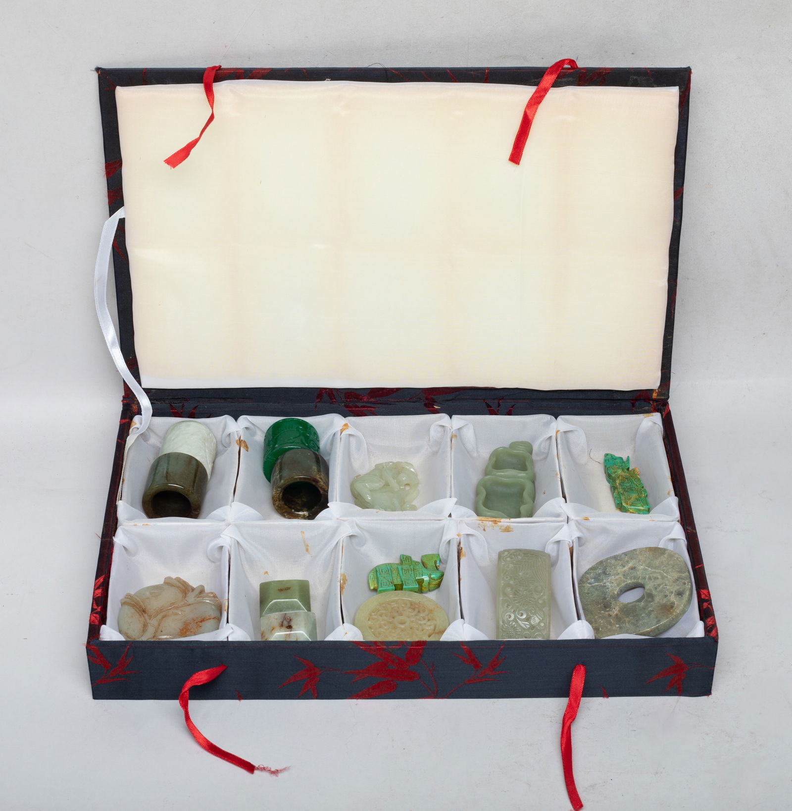 Set Chinese Export Jade, Stone Carvings: Including four thumb rings, two washers, two seals, two beast form pendants, a disc, a hair pin reticulated with bird and flowers, a monkey and peach form pendant, and a circular plaque reticulated