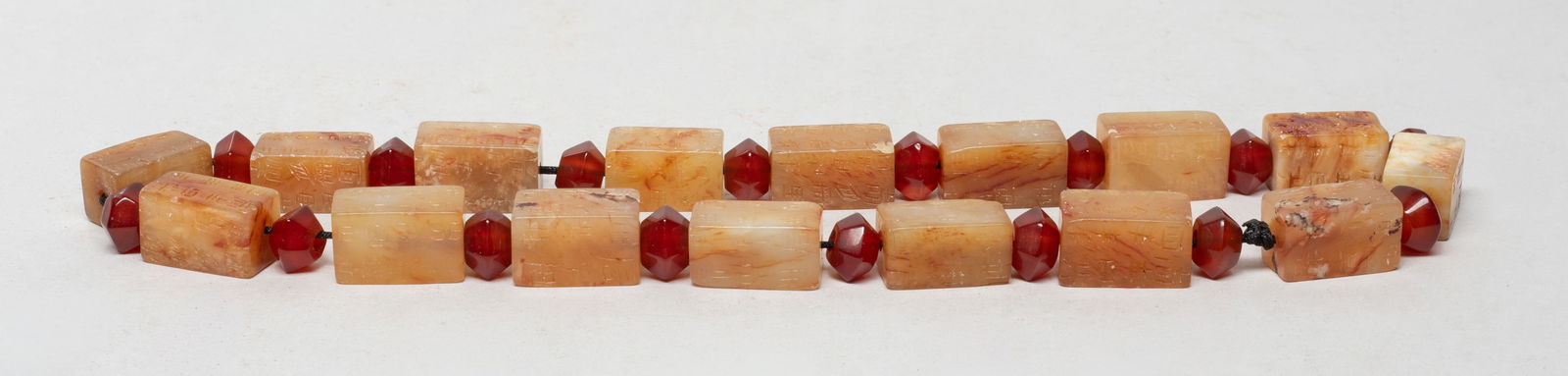 Chinese Russet Jade, Cameo Agate Necklace: Chinese russet jade bead and cameo agate bead necklace, the jade beads incised with characters. Approx. 19 inch L.