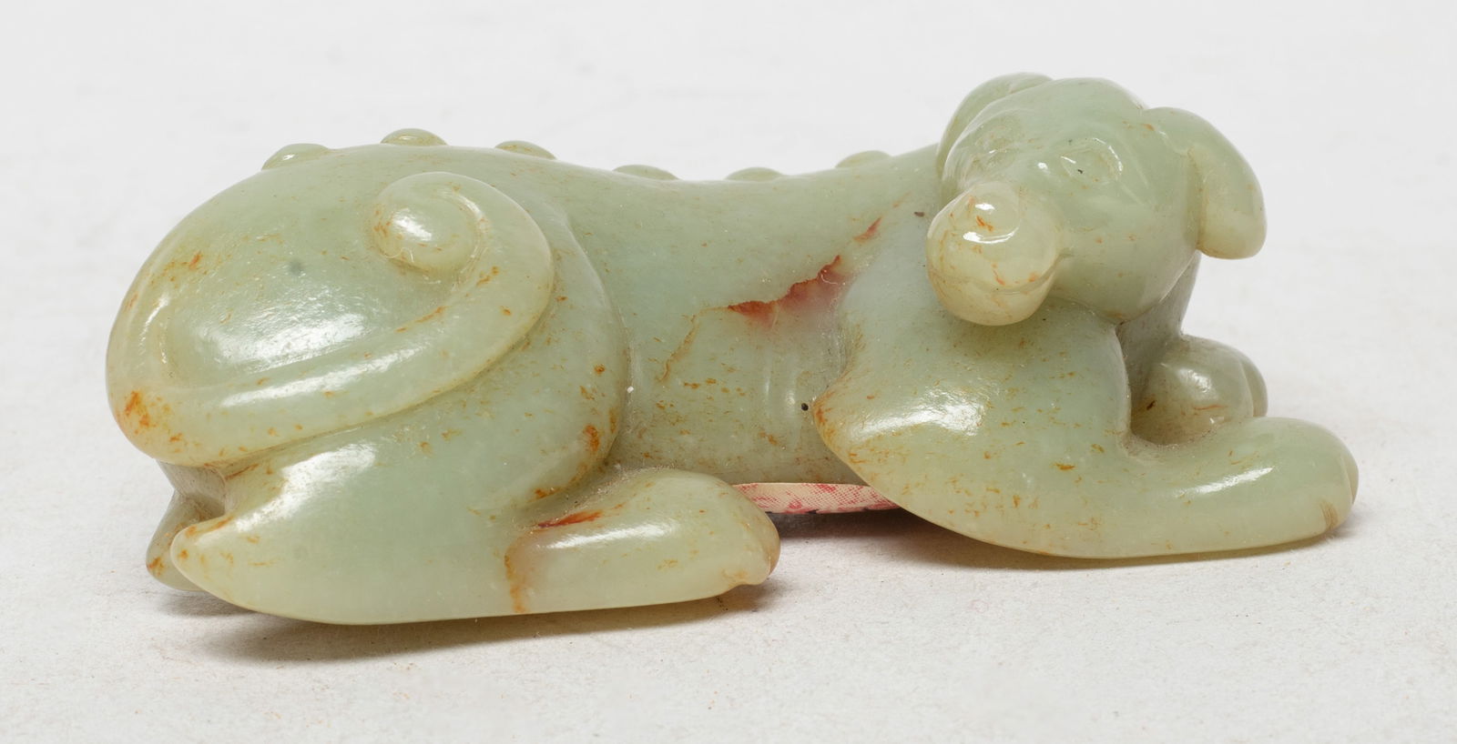 Lg Chinese Russet Jade Brush Stand of Dog: Deftly carved with its head turned backwards, with a naturalistically rendered nose, almond shaped eyes and floppy ears, the well-defined muscles accentuated with the knobbly spine terminating with a