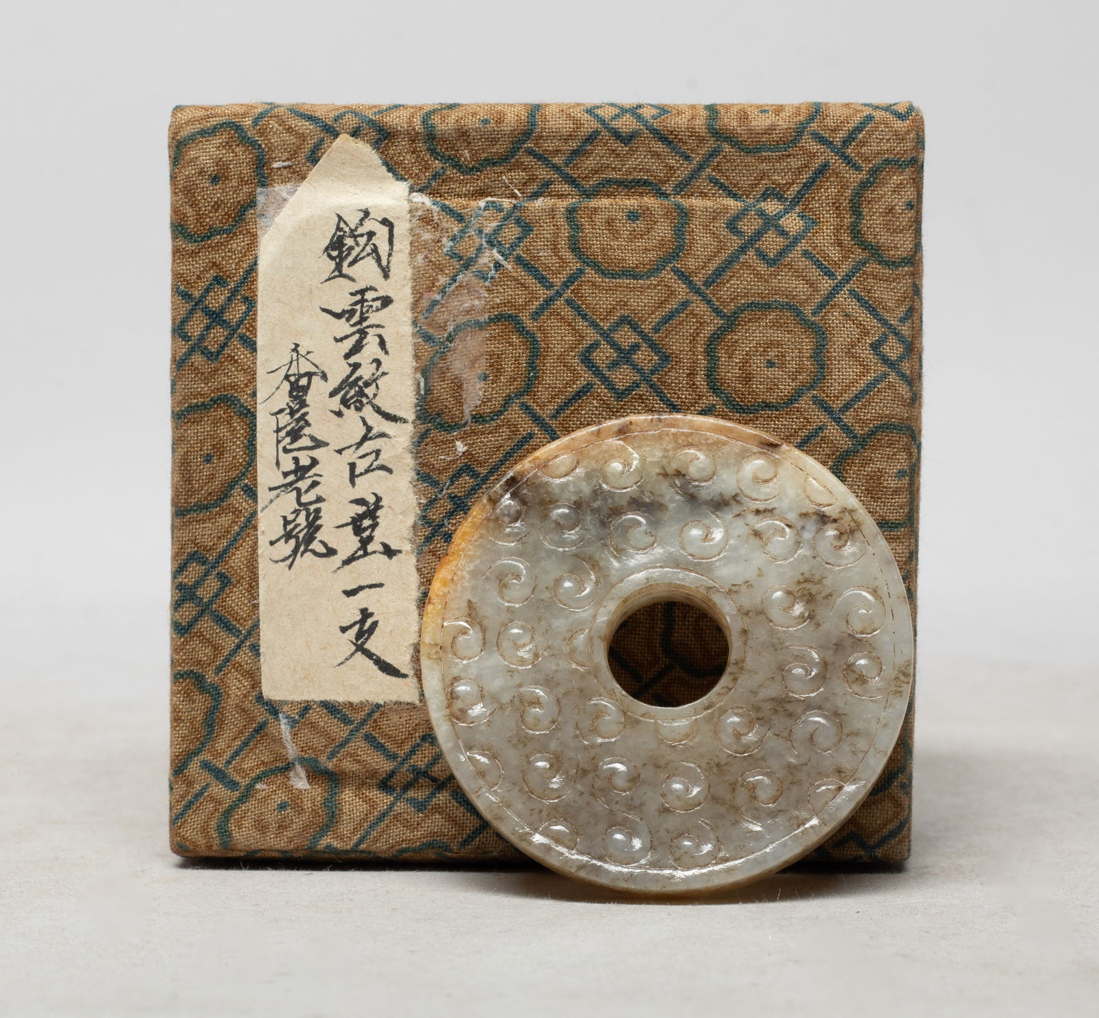 Estate Chinese Jade Carved Pendant w/ Box: Of circular shape, carved on both sides with raised spirals, with box. Approx. 2 inch D (jade size).