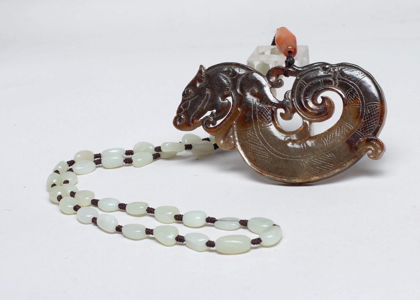 Vintage Chinese Jade Necklace w/ Pendant: Chinese white and russet jade bead necklace, with an agate bead and a large russet jade pendant carved of S-shaped dragon form. Approx. 4.05*2.2 inch (jade size).