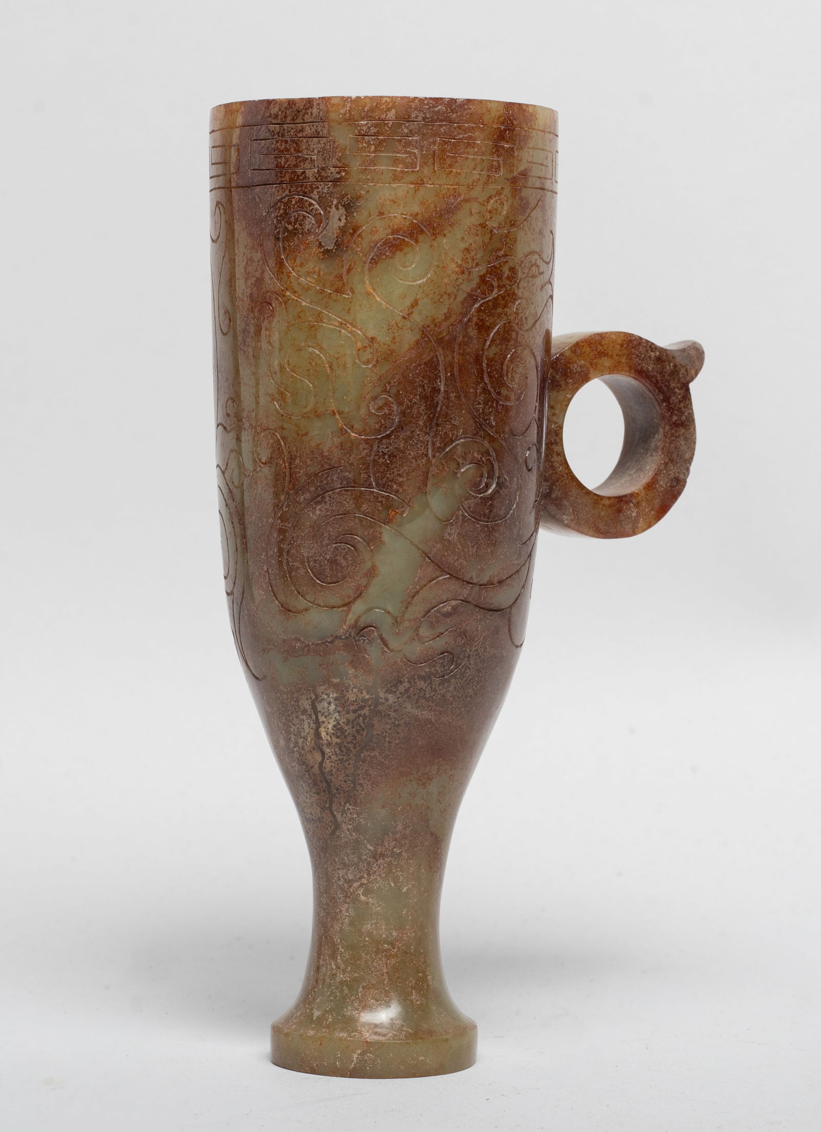 Chinese Russet Jade Carved Libation Cup: Tall Chinese russet jade cup, the exterior carved in low relief with archaistic beasts, flanked by a raised loop handle. Approx. 5.5*3.1*2 inch.