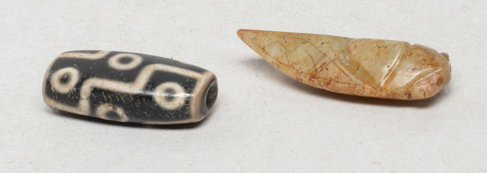 Chinese Jade Carved Cicada & Dzi Bead: Including a russet jade carved cicada form toggle and a dzi bead. Approx. 2.07*0.77*0.52 inch (jade size).