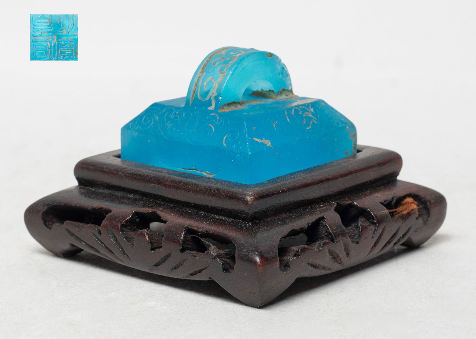 Rare Chinese Sapphire Glass Seal w/ Base: The sapphire glass seal of almost square section, the sides incised with stylized scrolls, the hand incised cloud motif, with a matched wood base. Approx. 1.7*1.67*1.17 inch (w/o base).