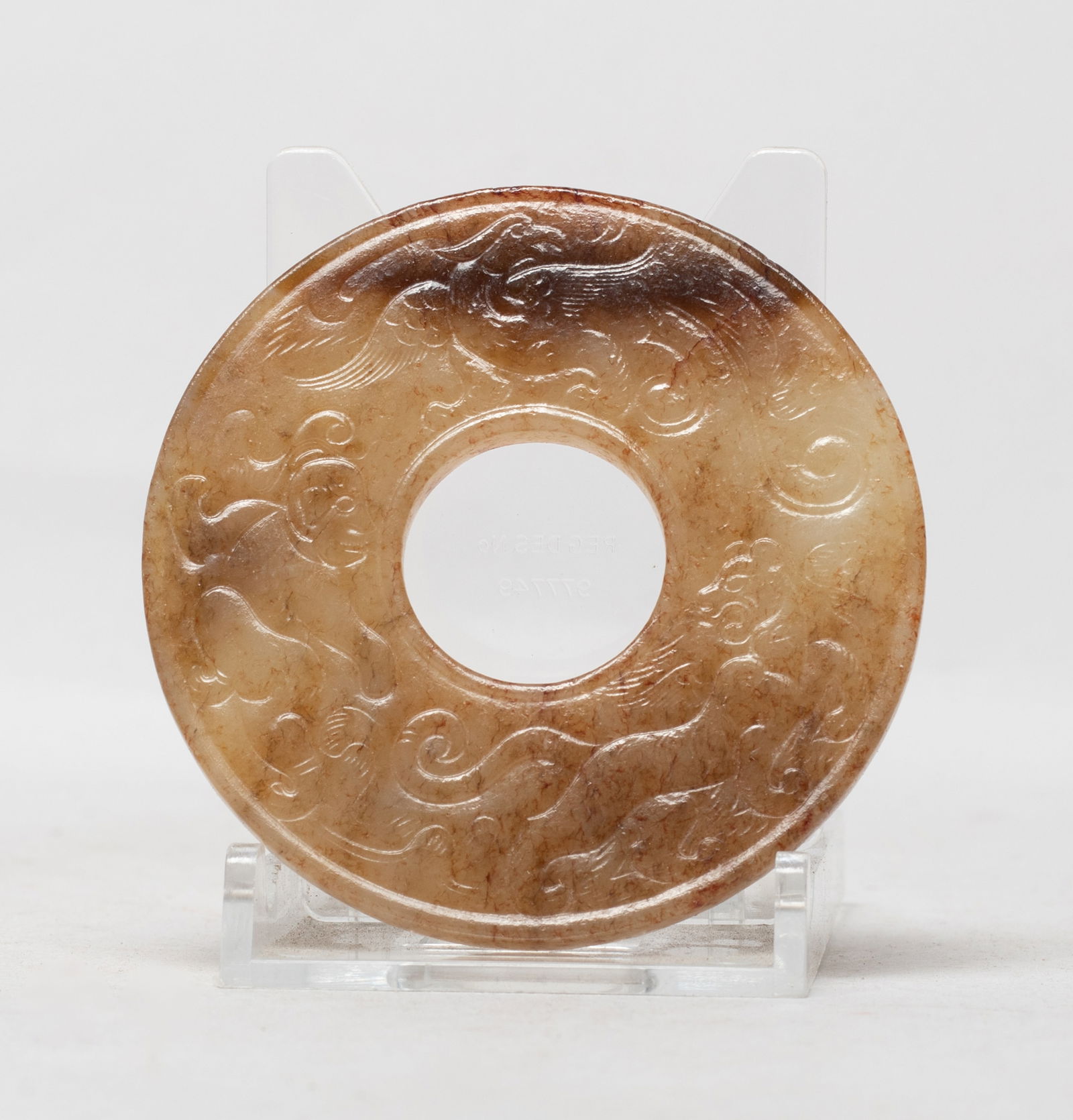 Chinese Russet Jade Carved Bi: Of circular shape, either side carved in low relief with a beast, a bird and a figure, pierced with an aperture at the centre. Approx. 2.7 inch D.