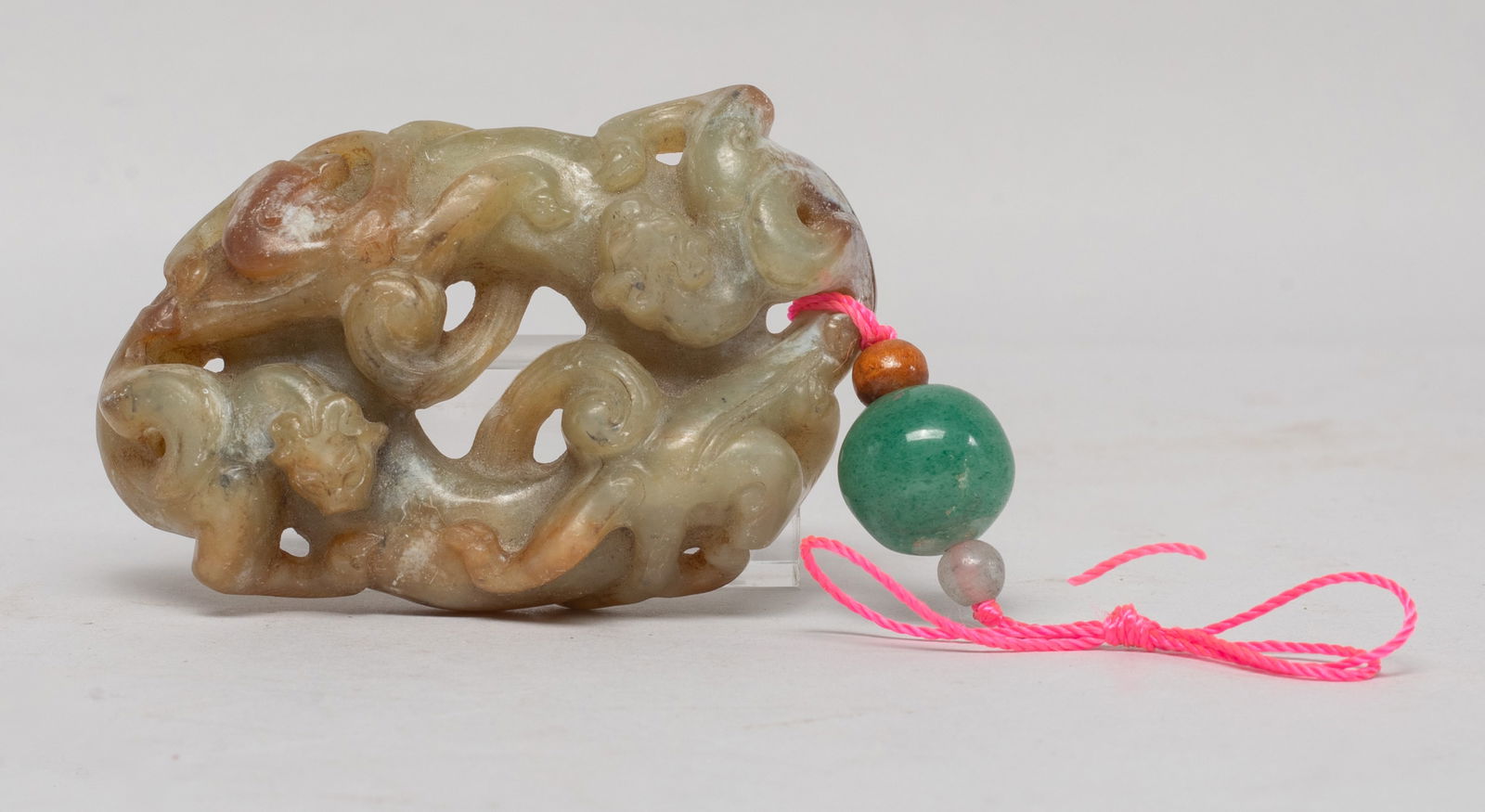 Chinese Russet Jade Dragon Pendant: Chinese russet jade pendant of circular shape, carved in high relief with two chi dragons sinuous around the pendant, with three stone beads. Approx. 2.4*1.5 inch. The Estate of the Store Closed