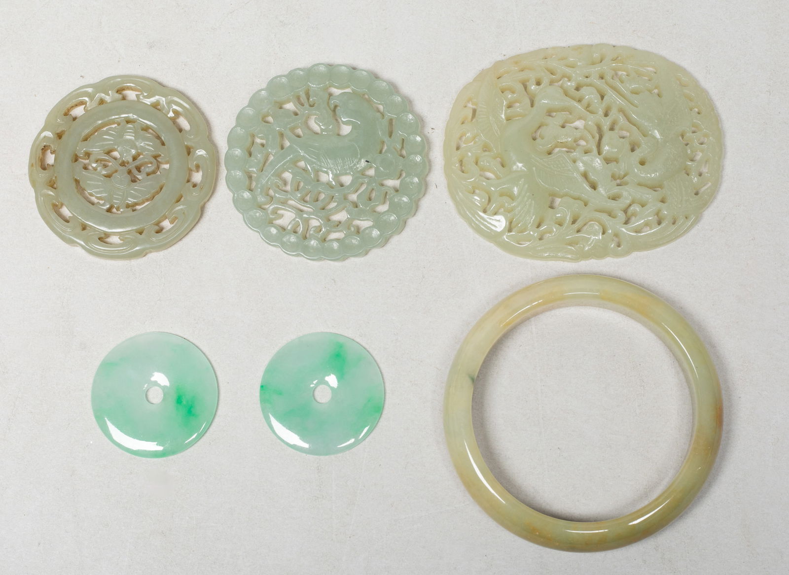 Set Chinese Jade/ Stone Carvings: Including a bangle, two discs, and three plaques carved in openwork with butterflies, birds and lingzhi stems, or bird and flowers. Approx. 2.73 inch outer diameter, 2.15 inch inner diameter (bangle
