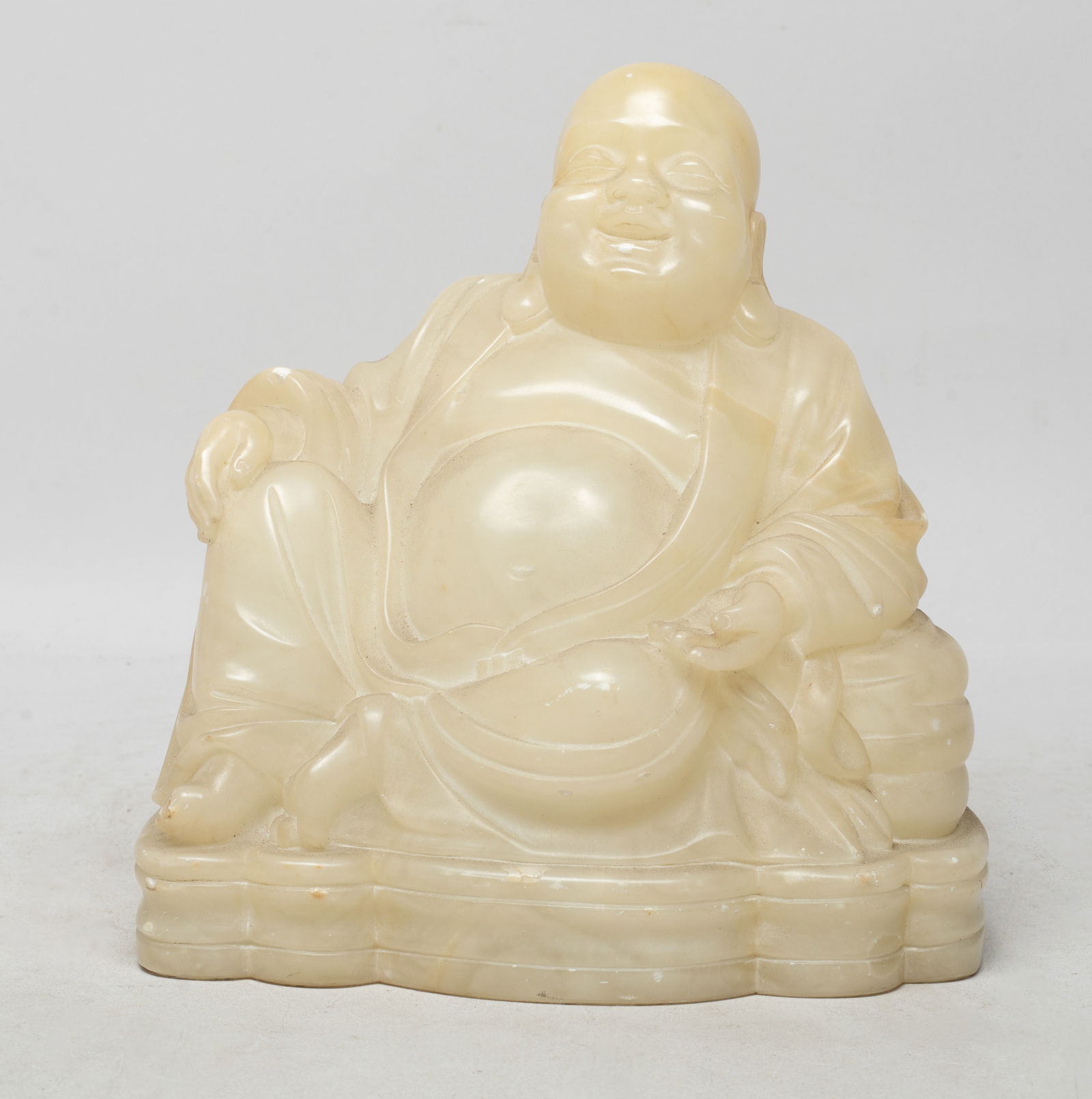 Large Vintage Chinese Stone Sculpture of Buddha: Heavy Chinese stone carved table sculpture of seated Buddha form, wearing a long flowing robe open at the chest. Approx. 7.1*6.6*4.4 inch.